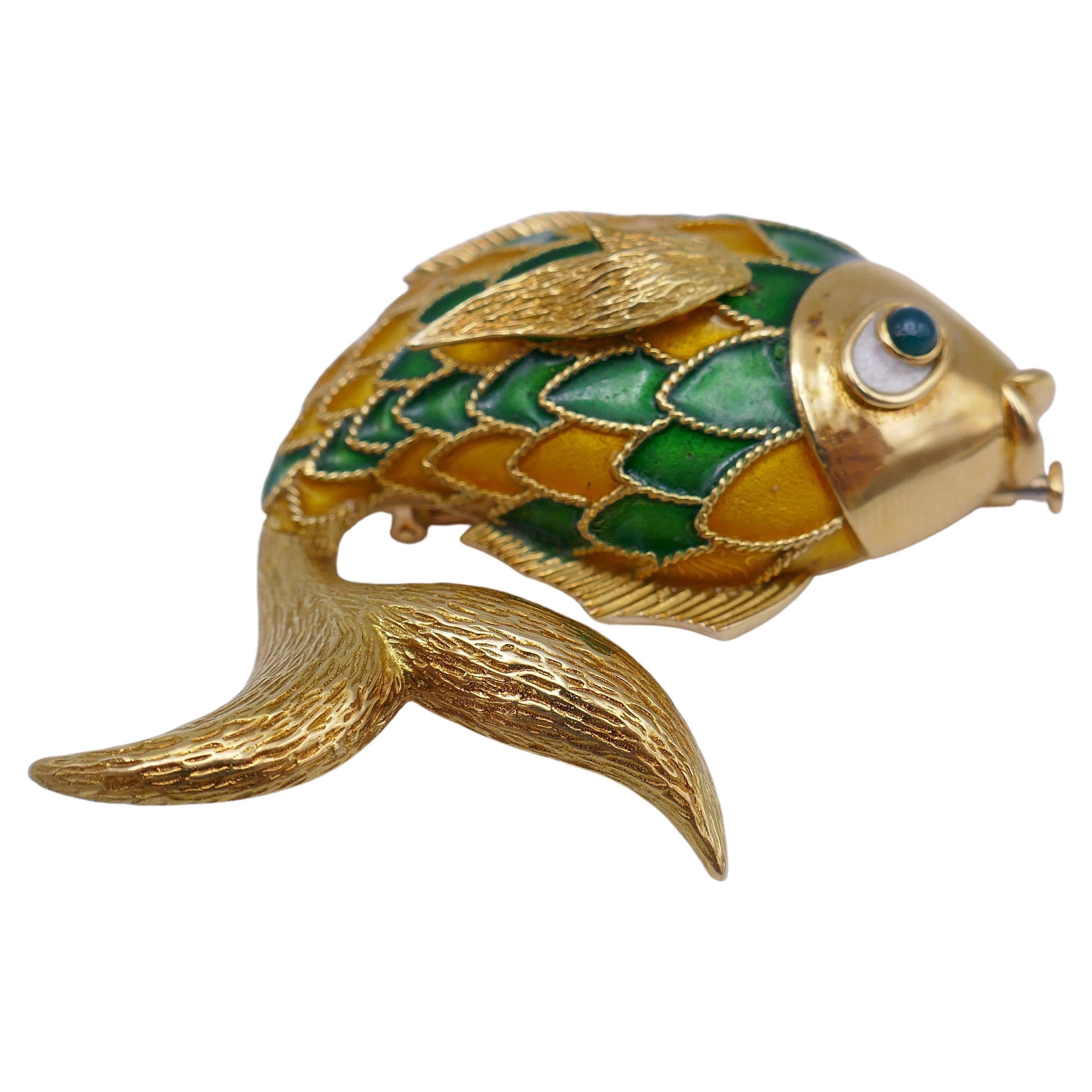 A Boucheron pendant and brooch in one. 
Made of 18k gold and enamel, this gorgeous Fish jewelry piece features great details that embrace the character of the item.
The finely braided gold scales accent with colorful yellow and green enamel. The