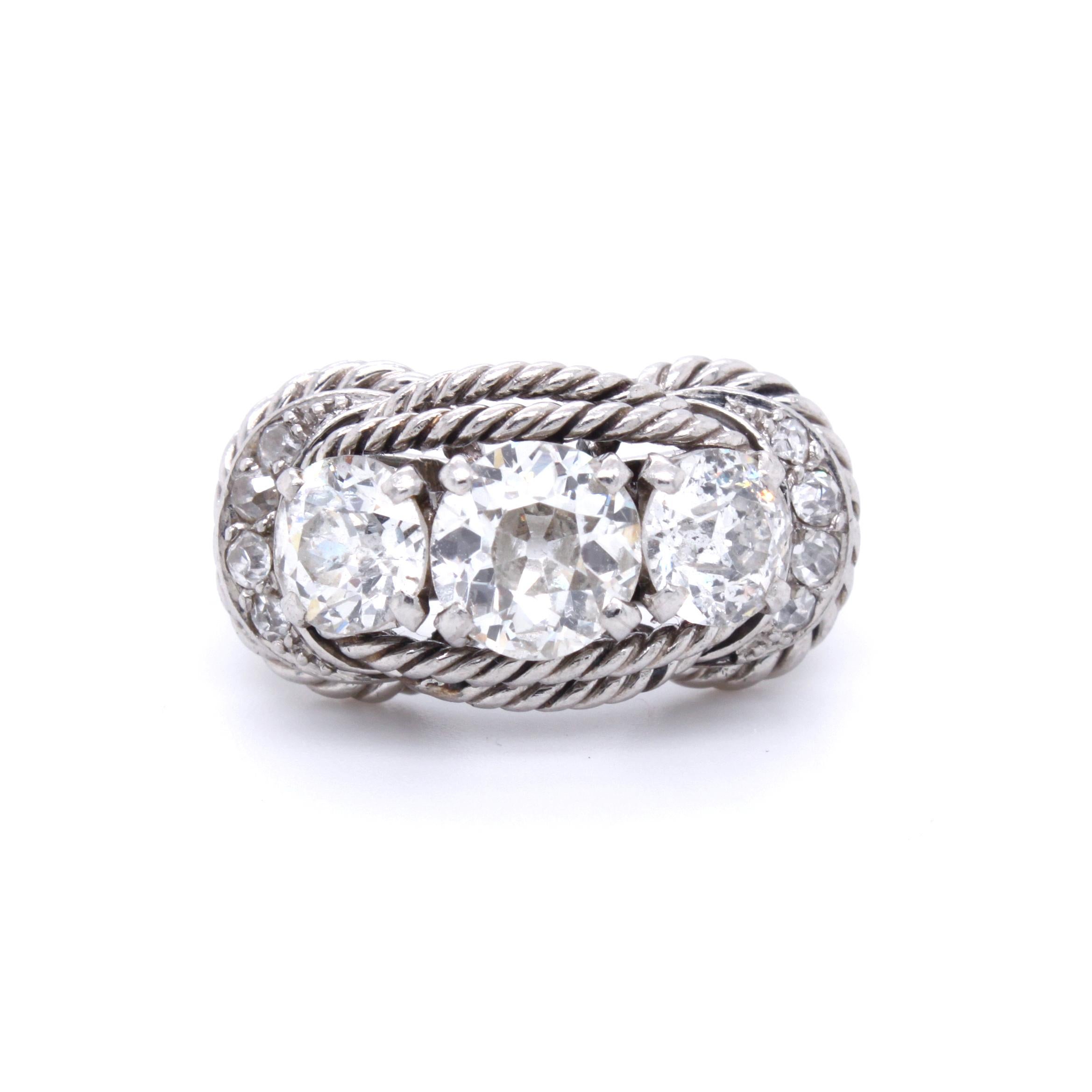 A chic Boucheron Retro Rope Three-Stone Diamond Ring, ca. 1940s

The ring has in the center an old-mine cut diamonds of ca. 1.1 carats (ca. I/VS), accentuated by two 0.6 carats (ca. I/SI) old-mine cut diamonds.
The exquisite design with the fine