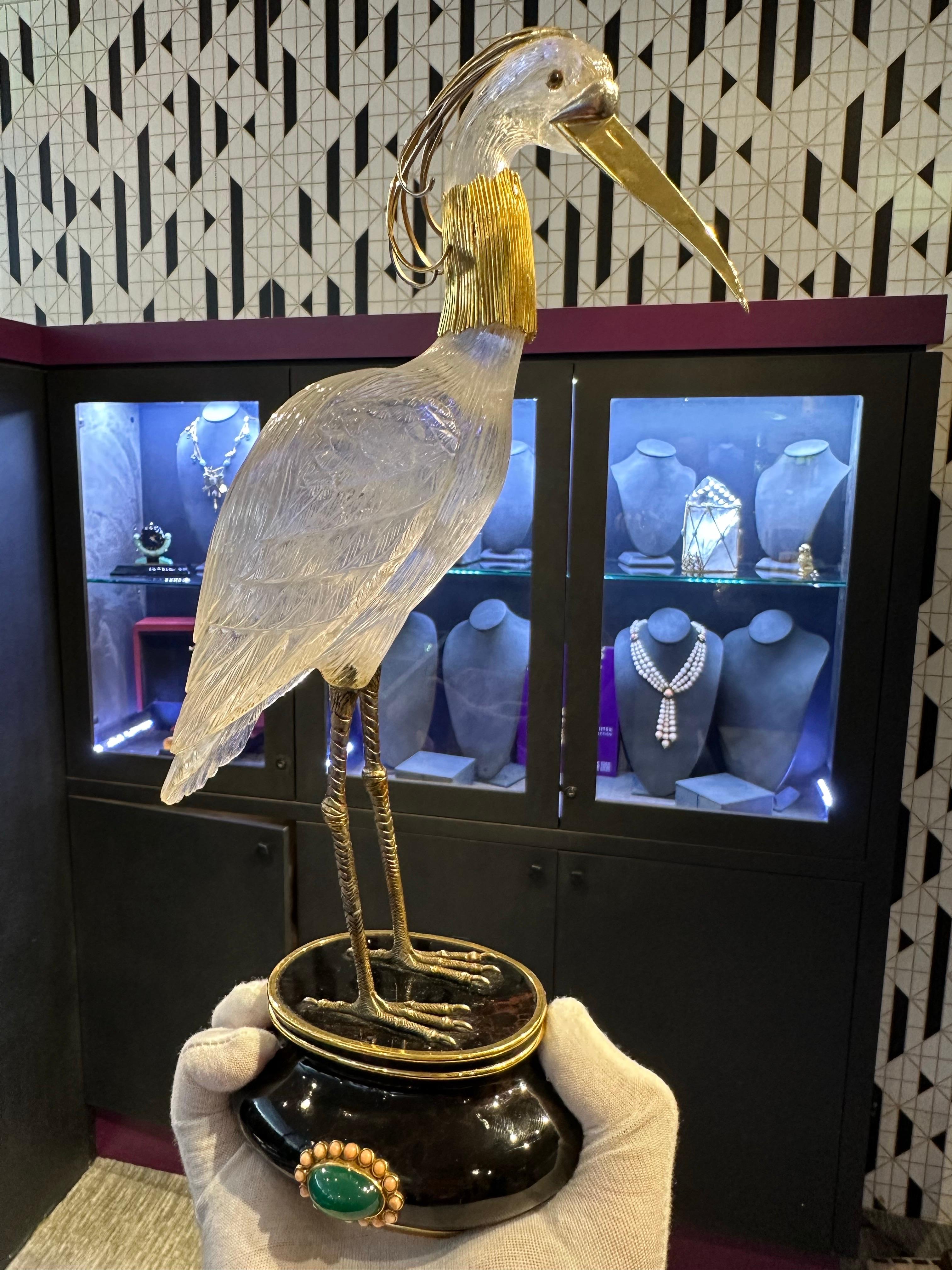 Boucheron Rock Crystal Heron 

A heron sculpture crafted from carved rock crystal set in yellow gold. The base is adorned with a cabochon chalcedony framed by 16 cabochon corals. 

Approximate Measurements: 11.62 x 5.5 x 3.75 in.
Sighed: Boucheron,
