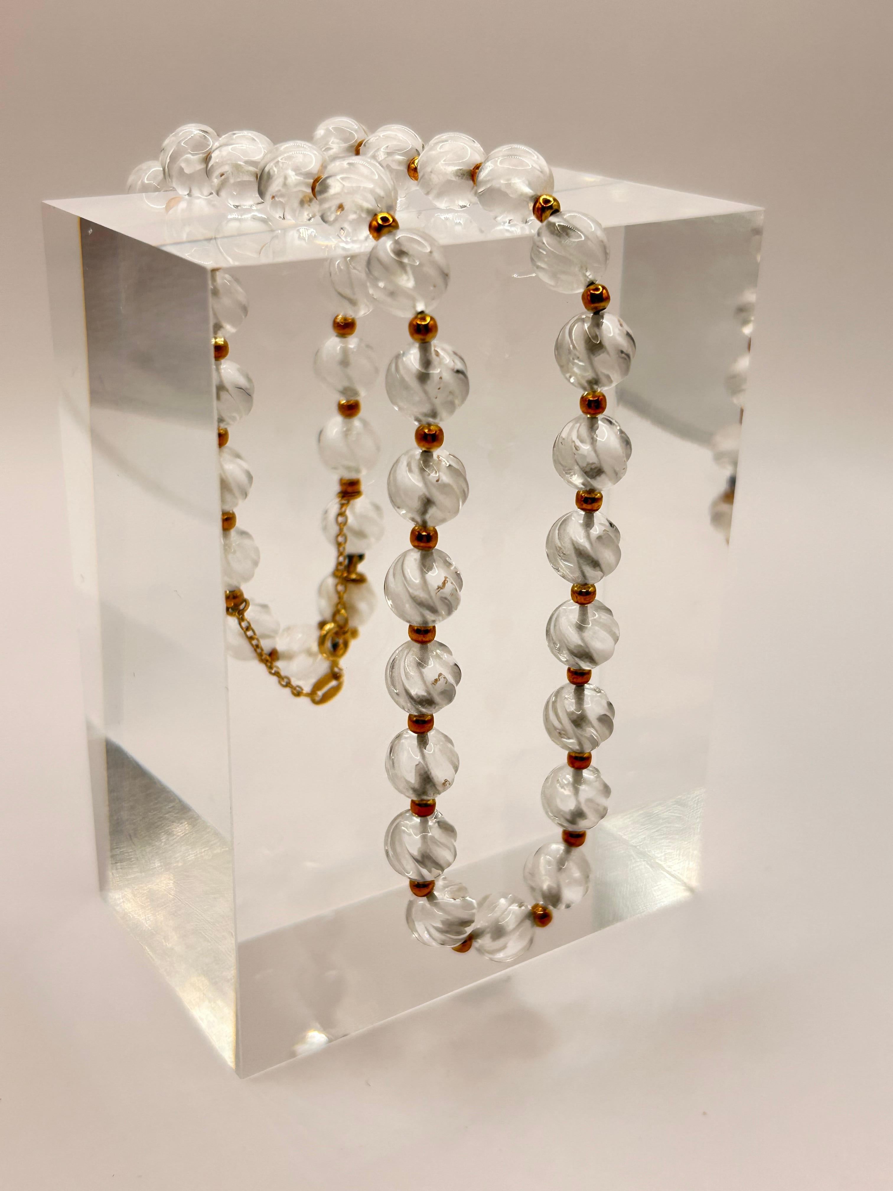 Timeless elegance!
Classic Rock Crystal necklace made by Boucheron Paris.  Twisted corrugated Rock Crystal beads are complemented with 18 karat yellow gold beads,
Stamped 