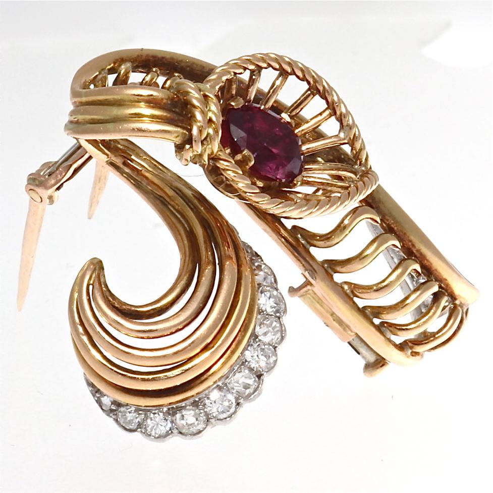A pioneer on Place Vendome, Boucheron is famous throughout the world for its bold, free style, that has conquered women's hearts for centuries. Featuring a glowing purplish-red ruby that is tied by a ribbon of 18k gold and diamonds. Signed Boucheron