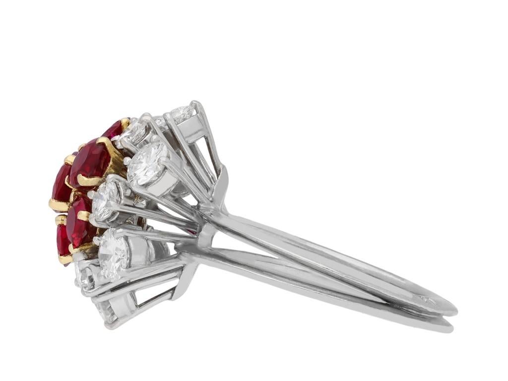 Boucheron ruby and diamond cluster ring. Set centrally with seven round old cut natural unenhanced Burmese rubies in open back claw settings with an approximate weight of 2.50 carats, encircled by twelve round brilliant cut diamonds in open back