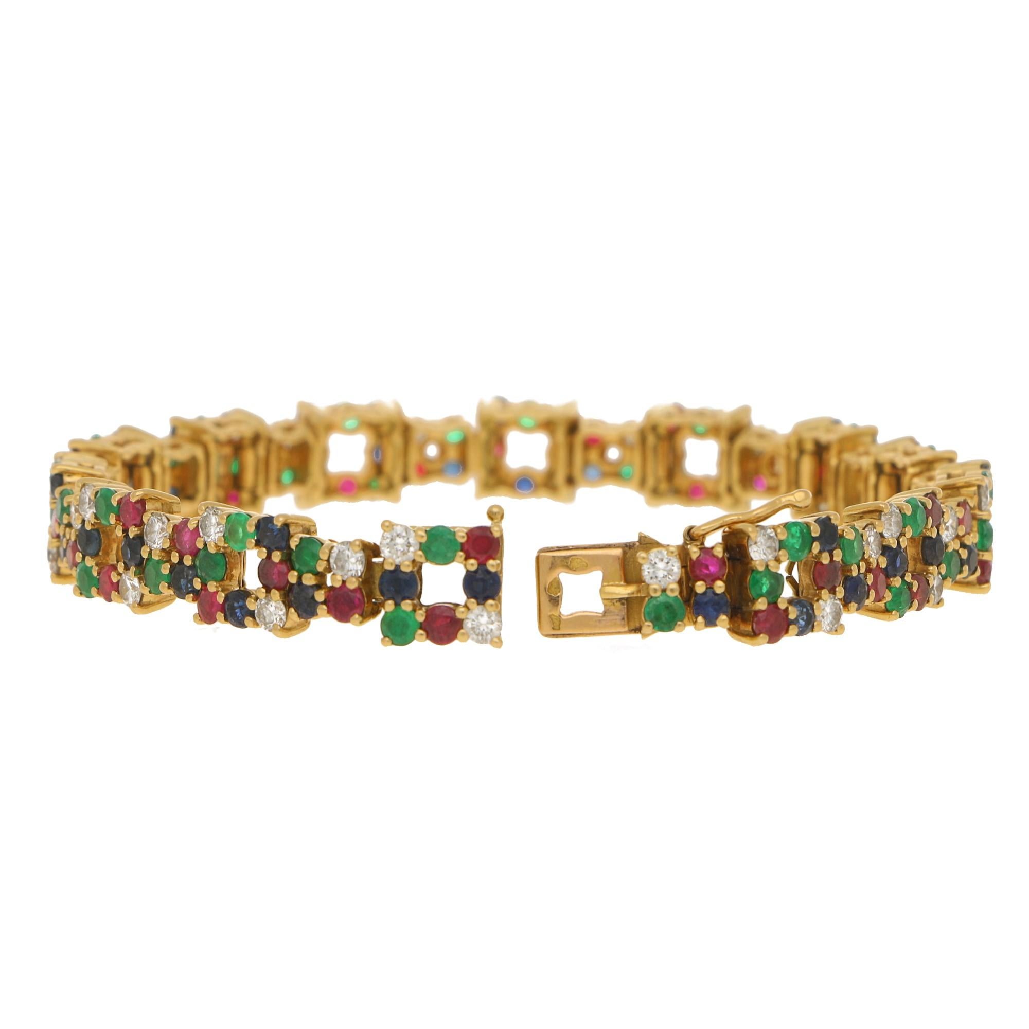 A beautiful ruby, emerald, sapphire and diamond bracelet set in 18k yellow gold, signed Boucheron.

The piece is comprised of 28 open square sections which are randomly yet equally set with round cut rubies. emeralds, sapphires and diamonds. This