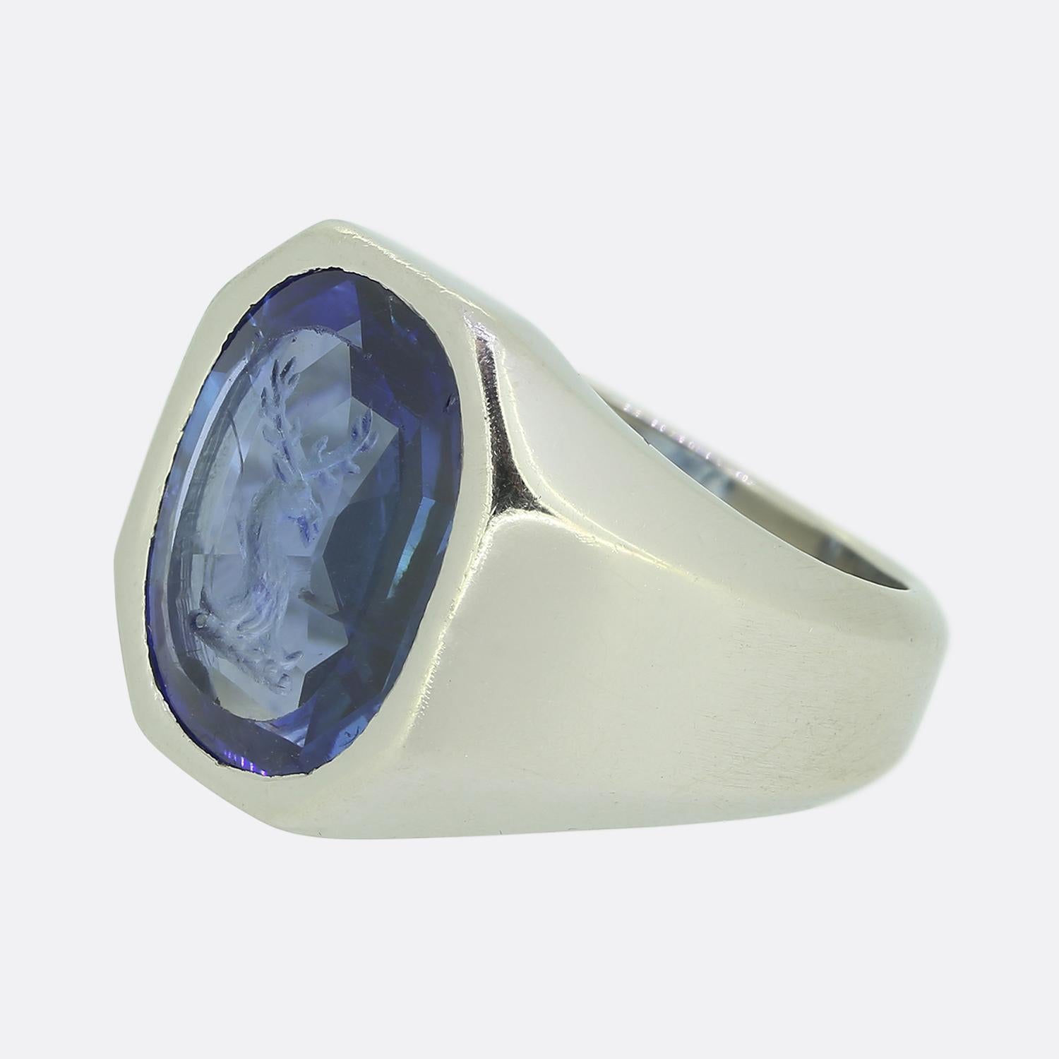 Here we have an outstanding signet ring from the world renowned French jewellery designer, Boucheron. This vintage piece has been crafted from platinum and features an oval faceted sapphire at the centre of the face with a highly detailed intaglio