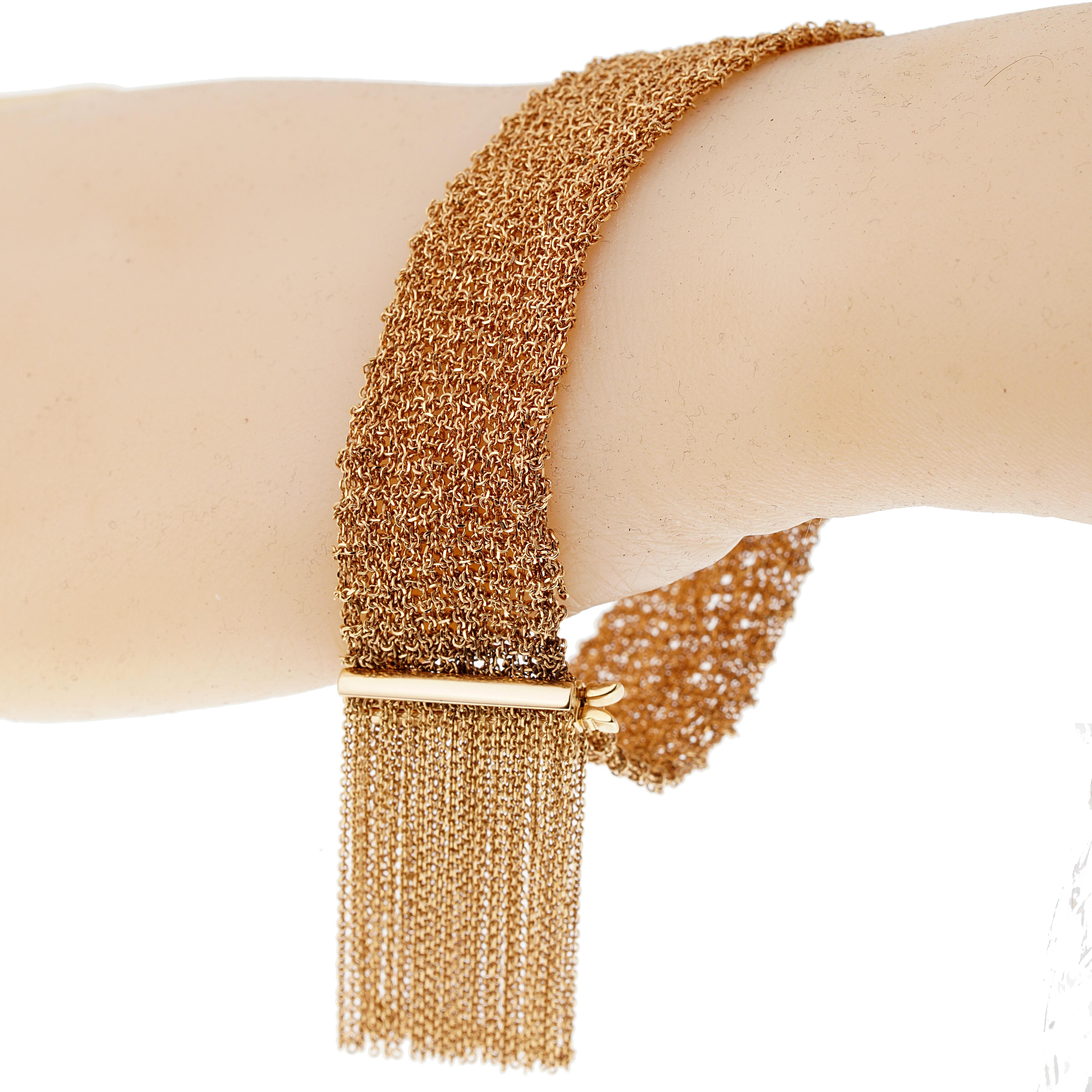 Le bracelet écharpe de Boucheron, incroyablement confortable, présente une fine chaîne à maillons, terminée par des franges serties d'or rose 18k, signée Boucheron et numérotée. Le bracelet a une longueur de 7