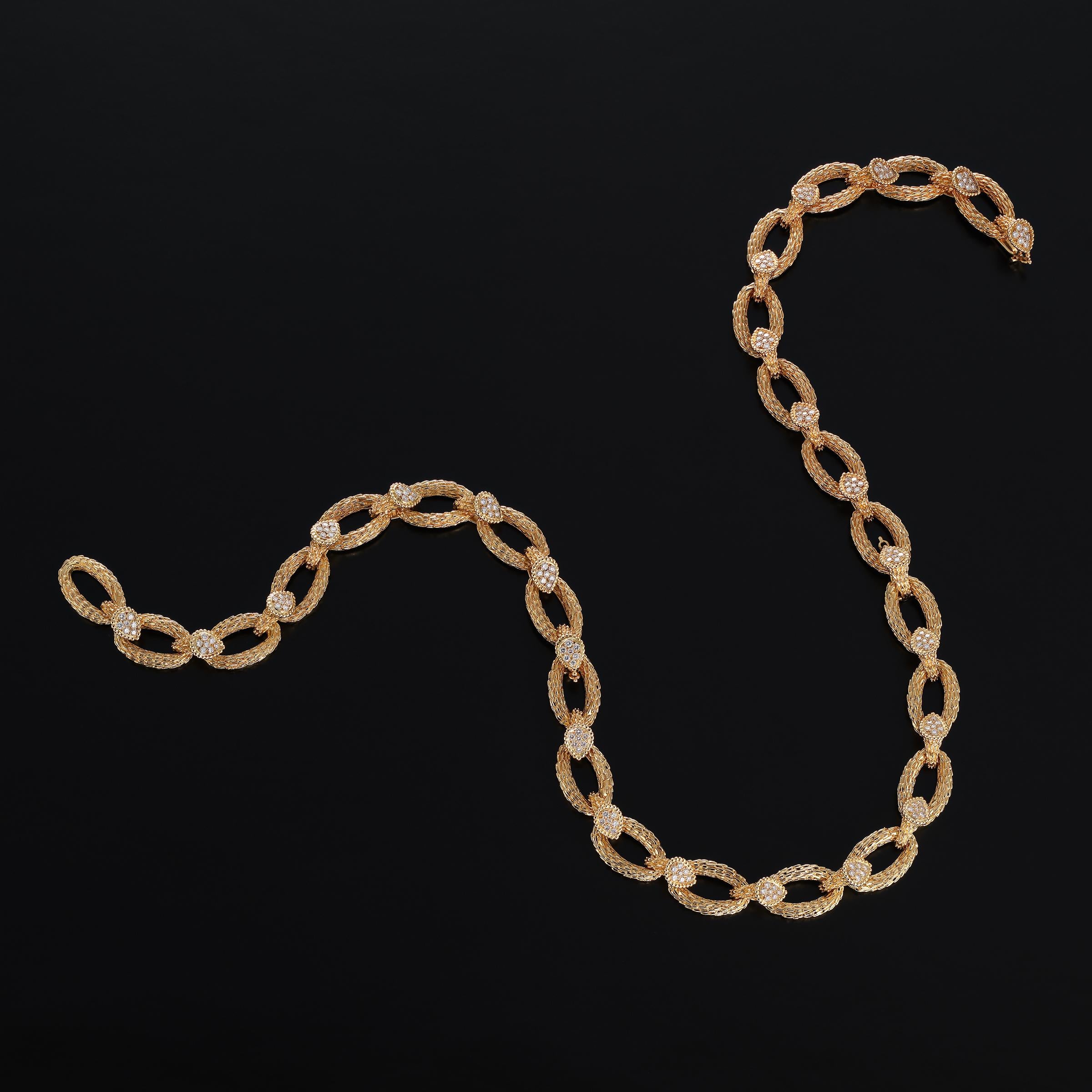 Splendid Boucheron Serpent Boheme necklace and bracelet combination crafted in 18 karat yellow gold and featuring approximately 9 carats of sparkling pave-set diamonds. A wonderfully versatile piece that can be worn as either: 1) a longer