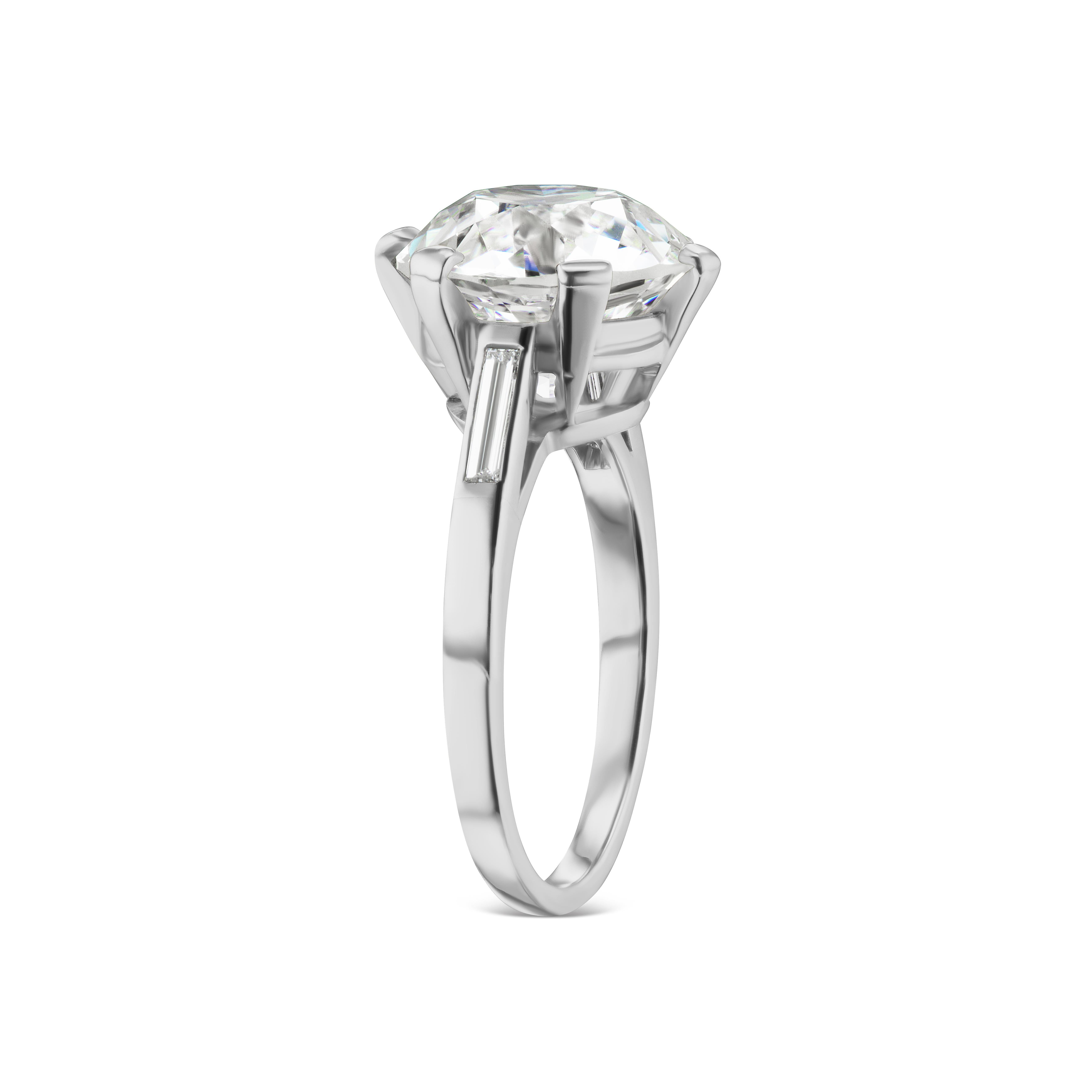 Sometimes you just get lucky.  This gorgeous and ultimately tasteful diamond solitaire ring is perfection. This 6.20 carats VS2 clarity Old European cut Diamond with a GIA grading report is mounted with a clean straight single baguette on each side.