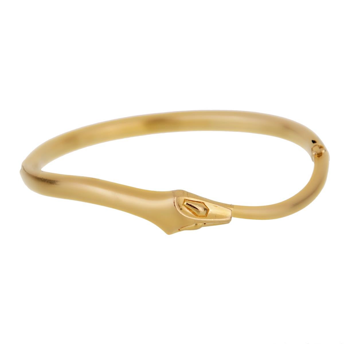 A fabulous vintage Boucheron snake hinged bangle in 18karat yellow gold, designed as a snake seamlessly coiling around the wrist.