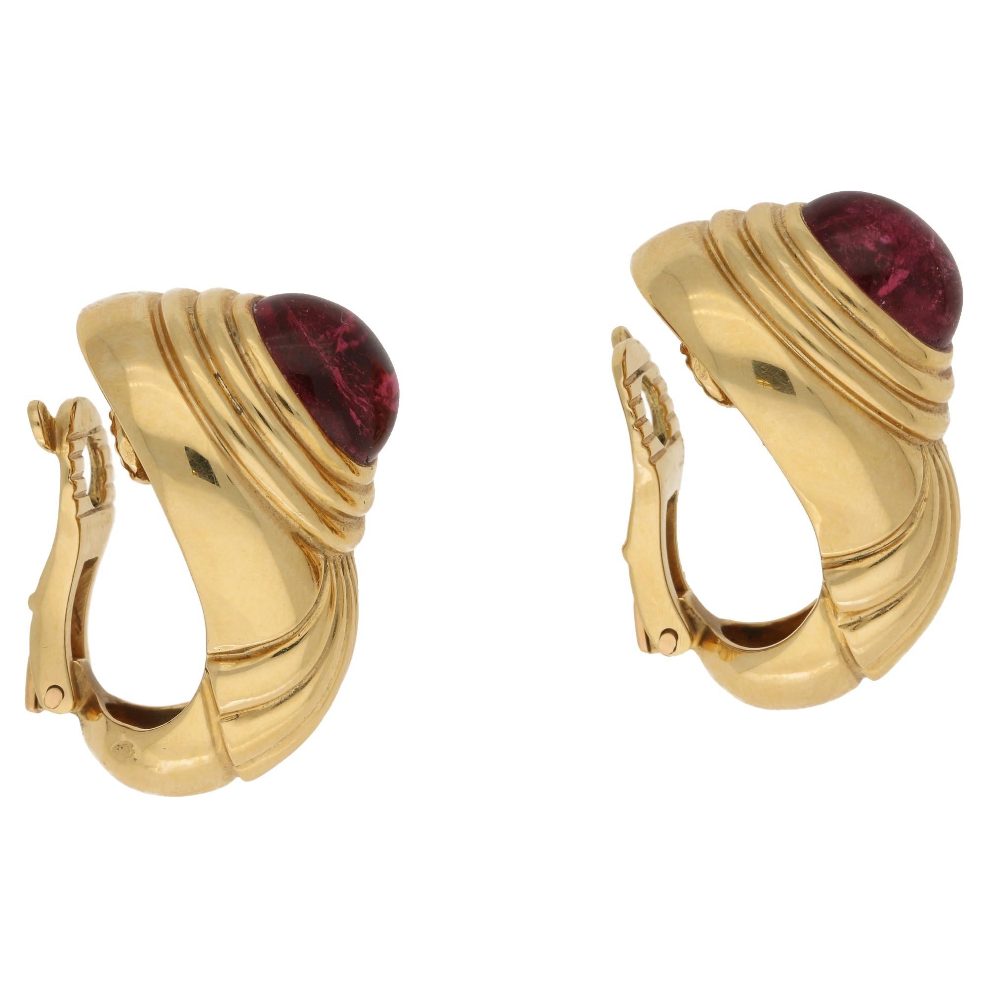 A fine pair of vintage signed boucheron earrings featuring pink tourmaline in a rich 18k ellow gold setting. These measure 16mm by 25mm approximately and are clip on earrings. We can however add a post for pierced ears.