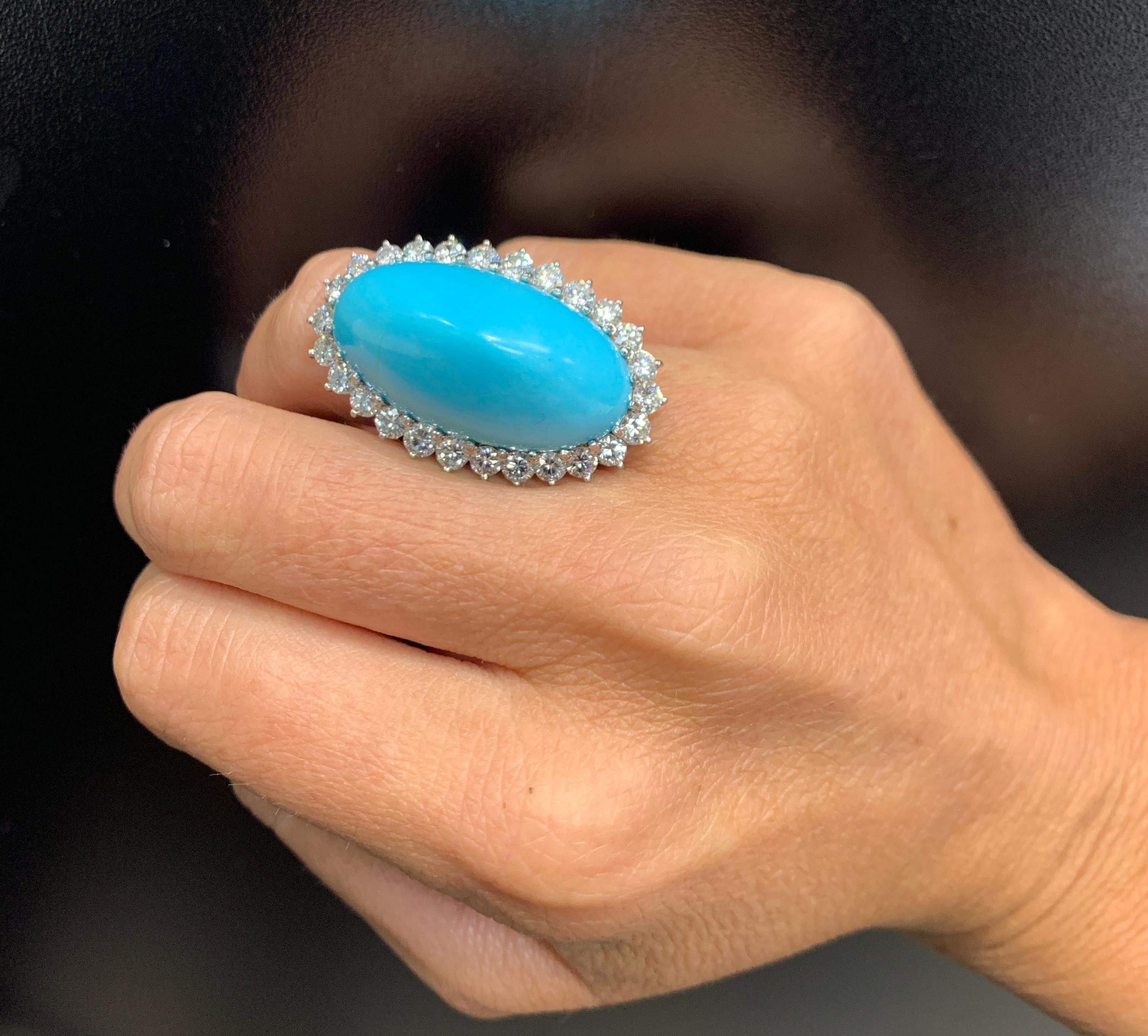 Boucheron Turquoise & Diamond Ring. 

 A cocktail ring featuring 1 large cabochon turquoise surround by a halo of round cut diamonds.

Ring Size: 6 

Complimentary resizing 

Signed, Boucheron

Metal Type: 18 karat white gold 