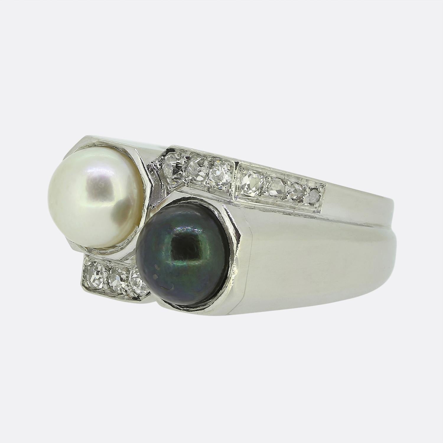 Here we have a captivating two-stone ring from the world renowned French jewellery house of Boucheron. This piece showcases a harmonious blend of elegance and contrast with a design that focally features two central pearls: one with a lustrous white
