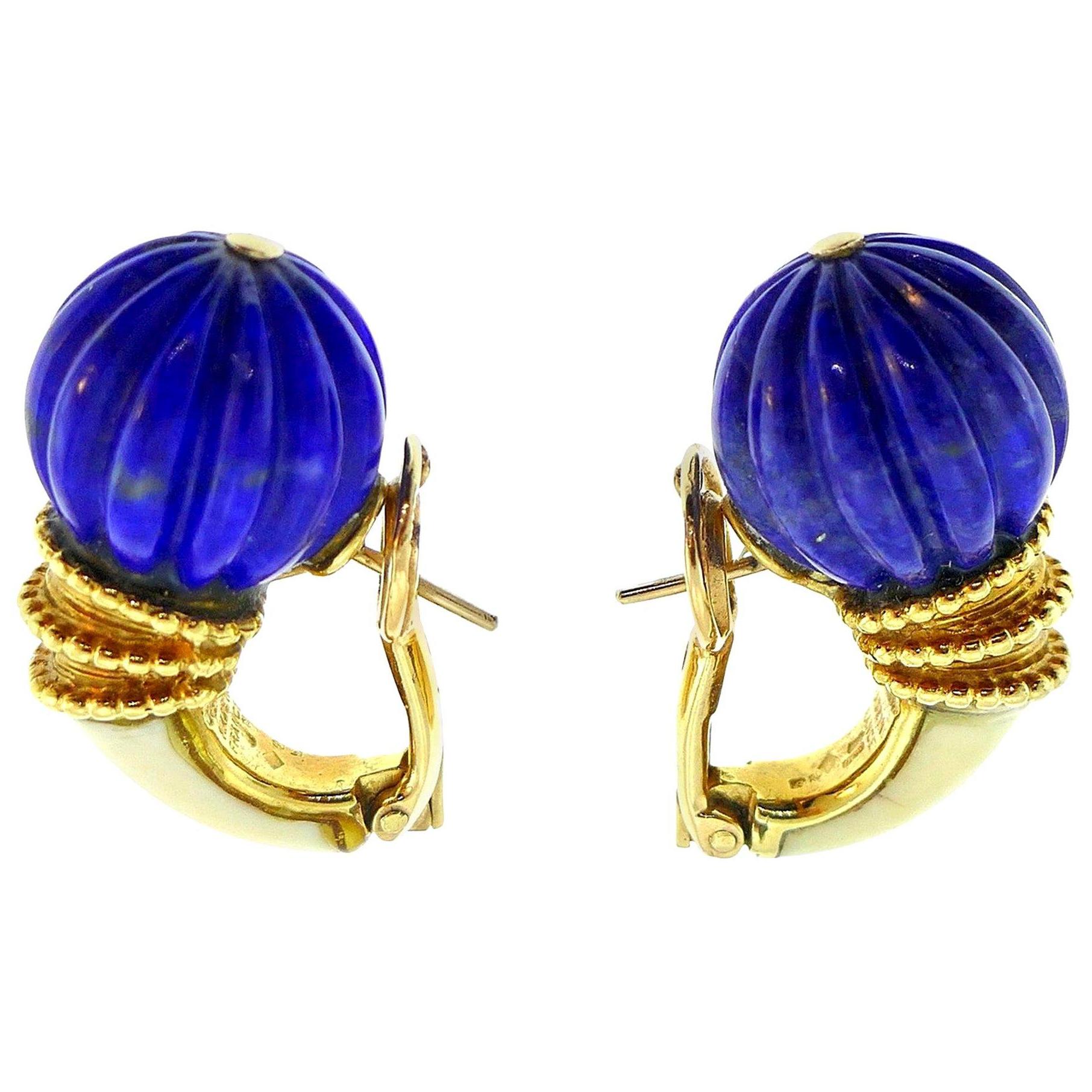 Vintage (c. 1970s) 18k yellow gold and carved lapis earrings by Boucheron.  
Stamped with the Boucheron maker's mark, French marks and a hallmark for 18k gold. 
Measurements: heights is 1 1/8