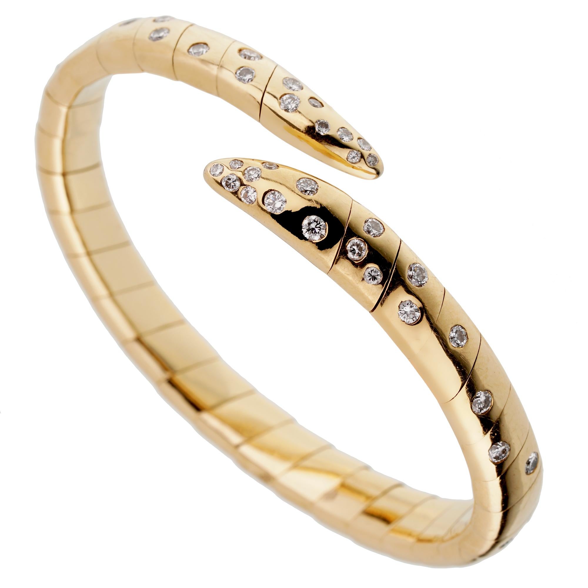 A magnificent Boucheron yellow gold bangle bracelet adorned with the finest round brilliant cut diamonds in shimmering 18k yellow gold. The bracelet has a weight of 56.4 grams and will fit a wrist of up to 7