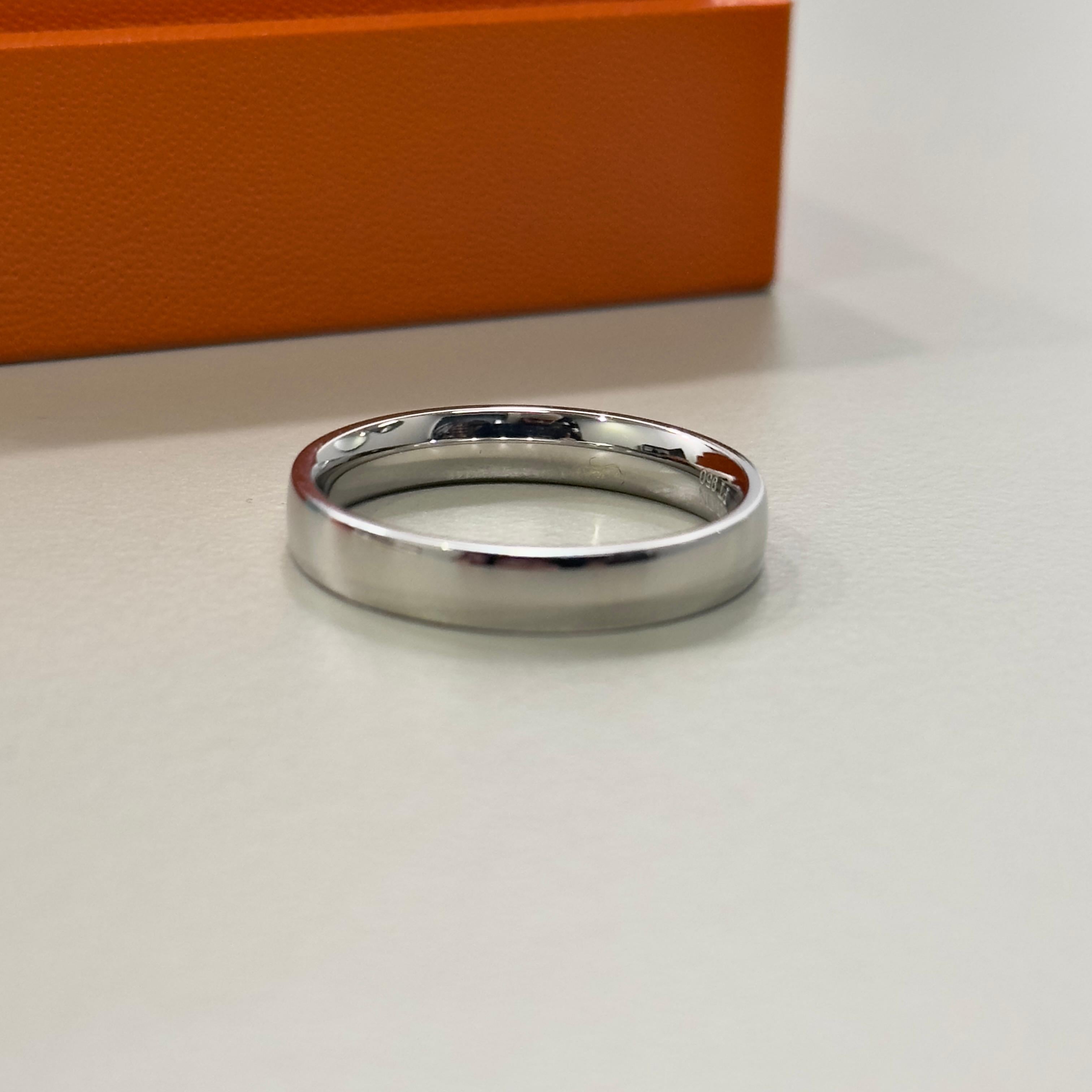 Embrace timeless elegance with the Boucheron Wedding Band, a exquisite piece crafted in platinum and bearing the distinctive hallmark of its renowned French heritage. This size T ring is a statement of sophistication, designed to be a symbol of your