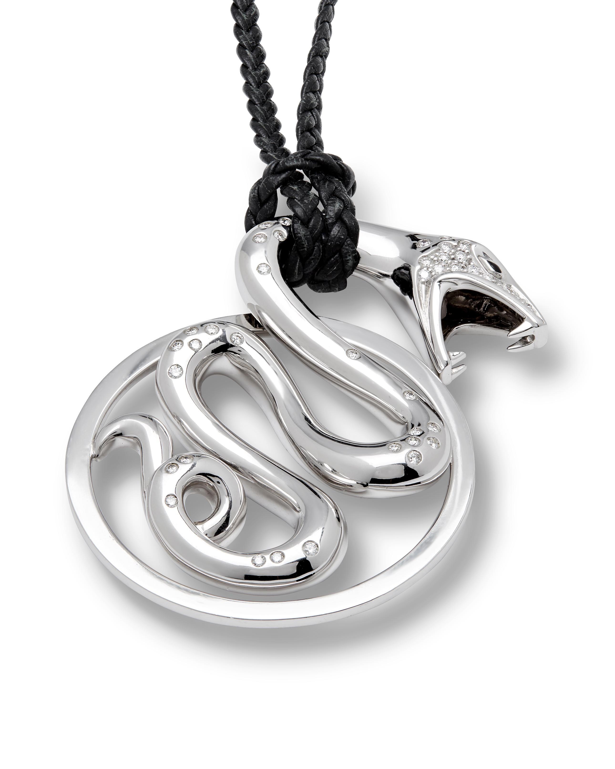 Boucheron Trouble large white gold and diamond pendant, with original braided black cord, pre-owned but in New condition. 

The Serpent, a symbol of protection, and an iconic design from the Maison Boucheron, part of the iconic animal collection,