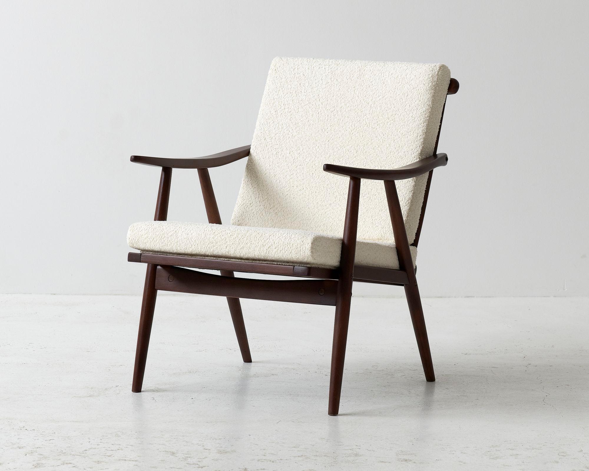 A unique armchair produced during the 1960's in former Czechoslovakia. Attributed to Thonet. Wooden frame cleaned, varnished, lacquered. Seating recreated and reupholstered in a creme boucle fabric. 