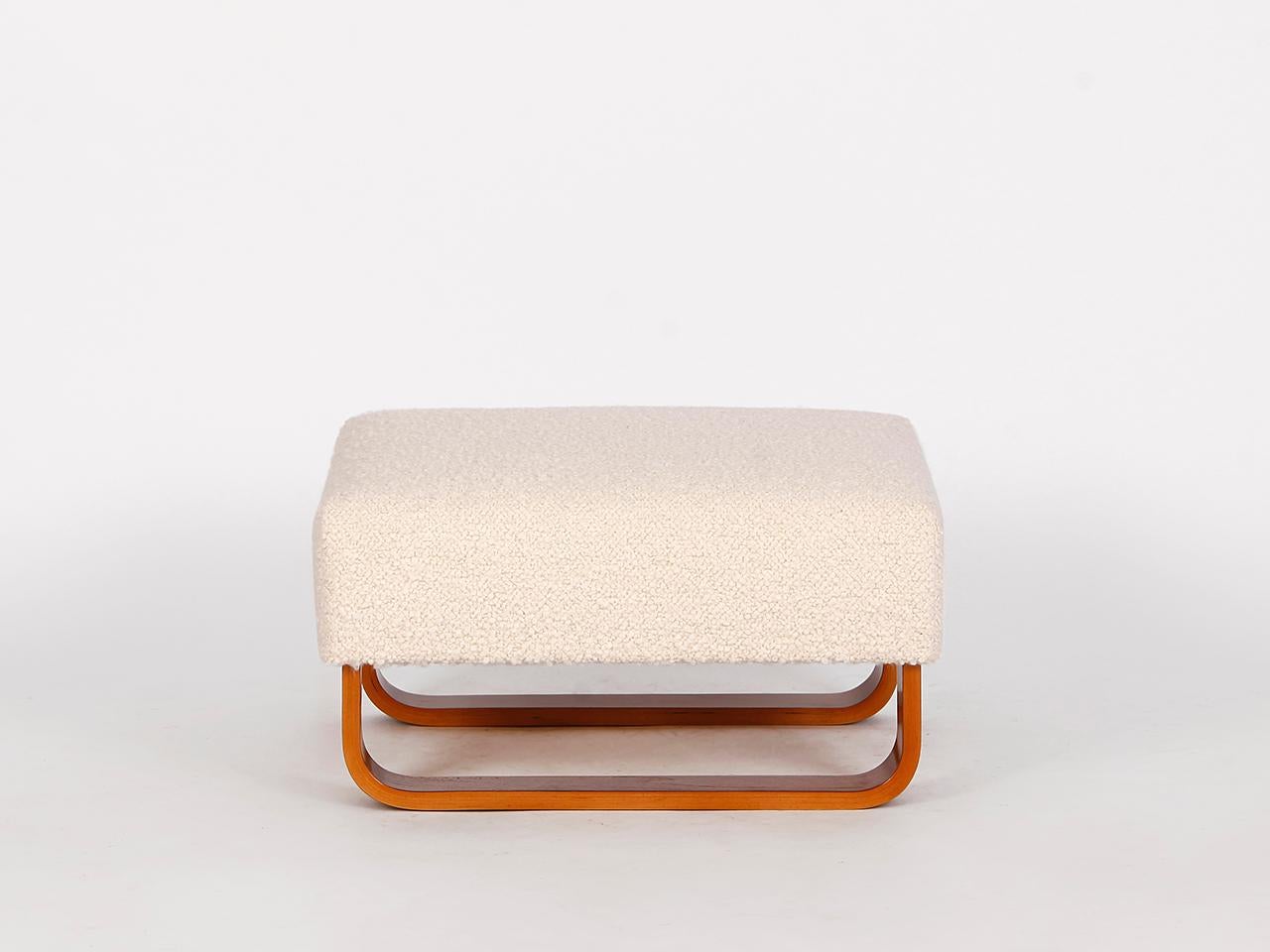 This midcentury stool footstool was made in the 1960s in former Czechoslovakia. The upholstery consists of a coconut fiber core, covered with a wonderfully soft English boucle cover made of wool. Completely restored. Very nice complement to our