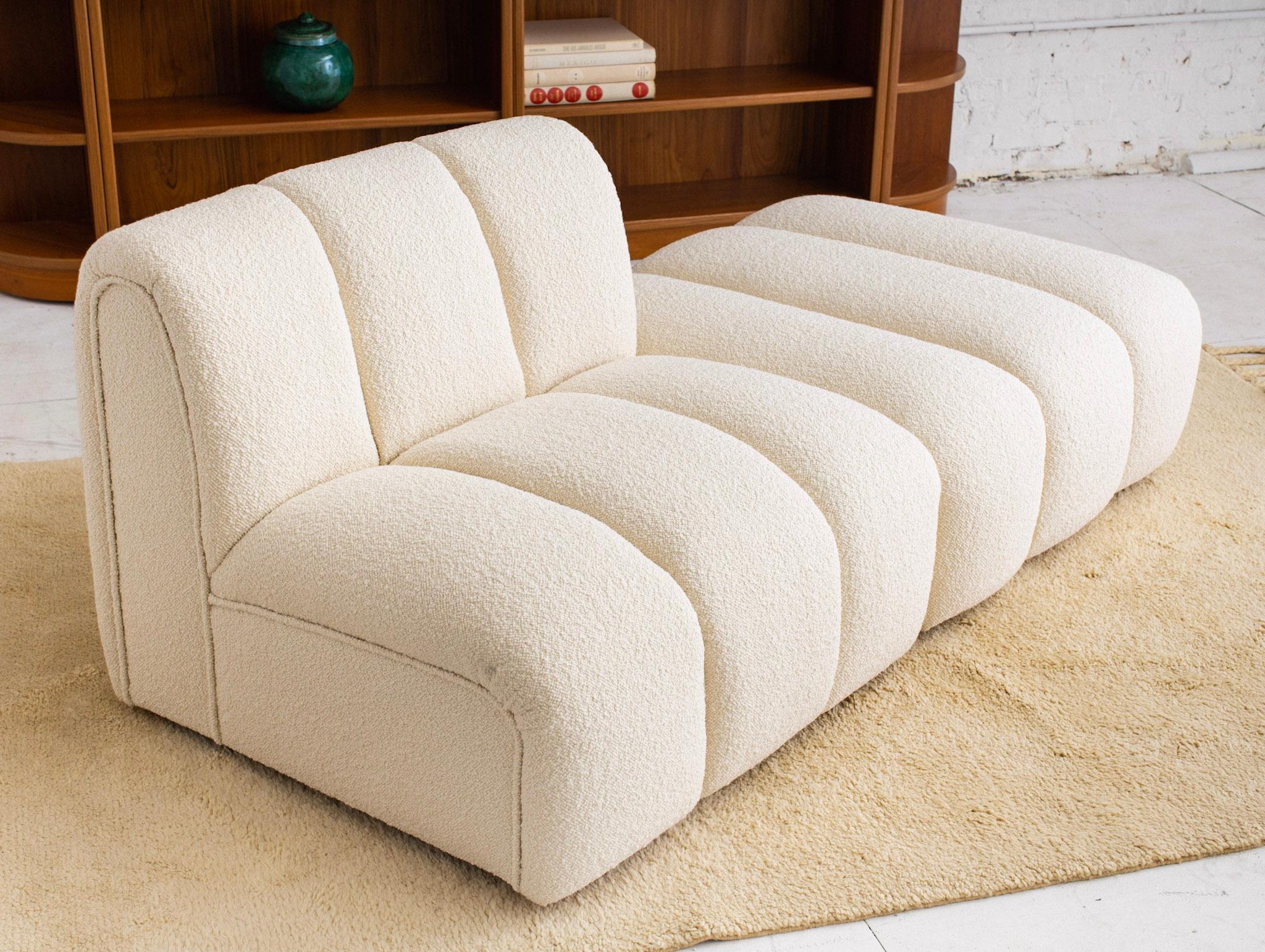 Channeled chair and ottoman in ivory wool boucle. Ottoman is on castors to allow for easy rearrangement. Produced by Bernhardt Furniture Co. The Flair Division, was created in 1958 to expand Barnhardt's offerings to include high-quality upholstered