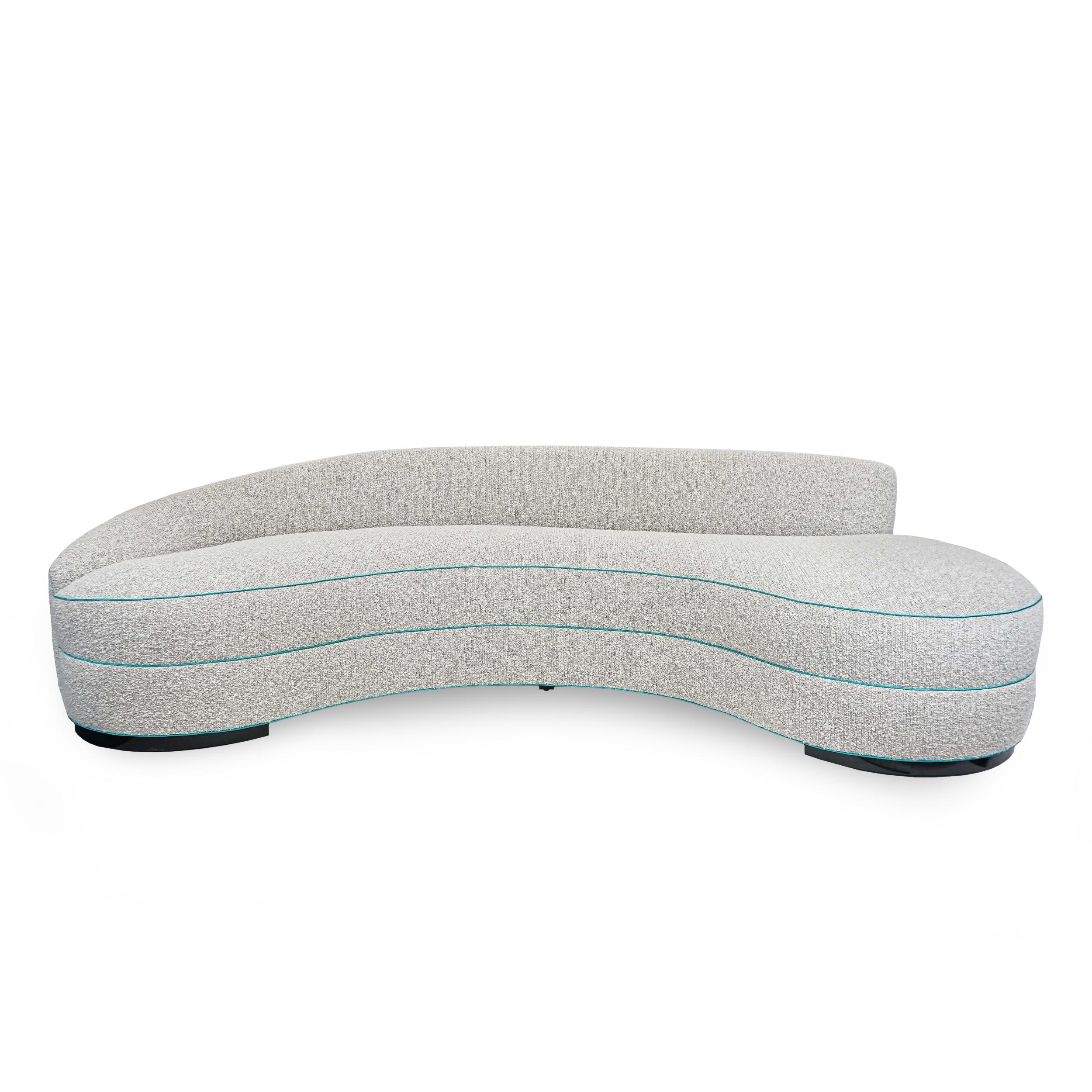 Mid-century modern curved sofa with tight seat and tight back. Upholstered in a light grey / tonal woven with variegated patches of ashy white boucle blend (alpaca, wool, mohair). Contrasted with turquoise sateen welting. Eight-way hand-tied springs