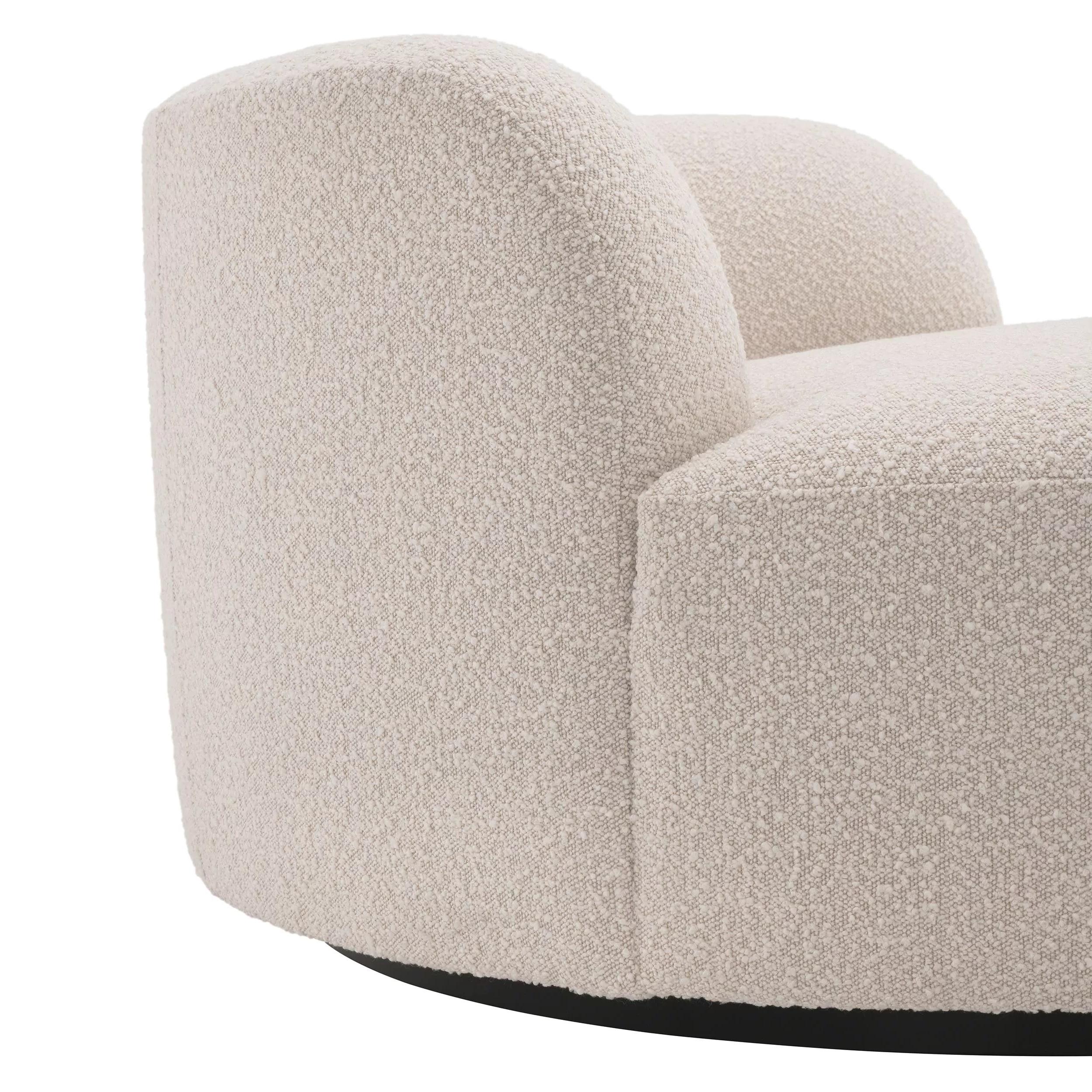 Welcoming and round shaped large armchair or sofa in bouclé fabric and black finishes base.