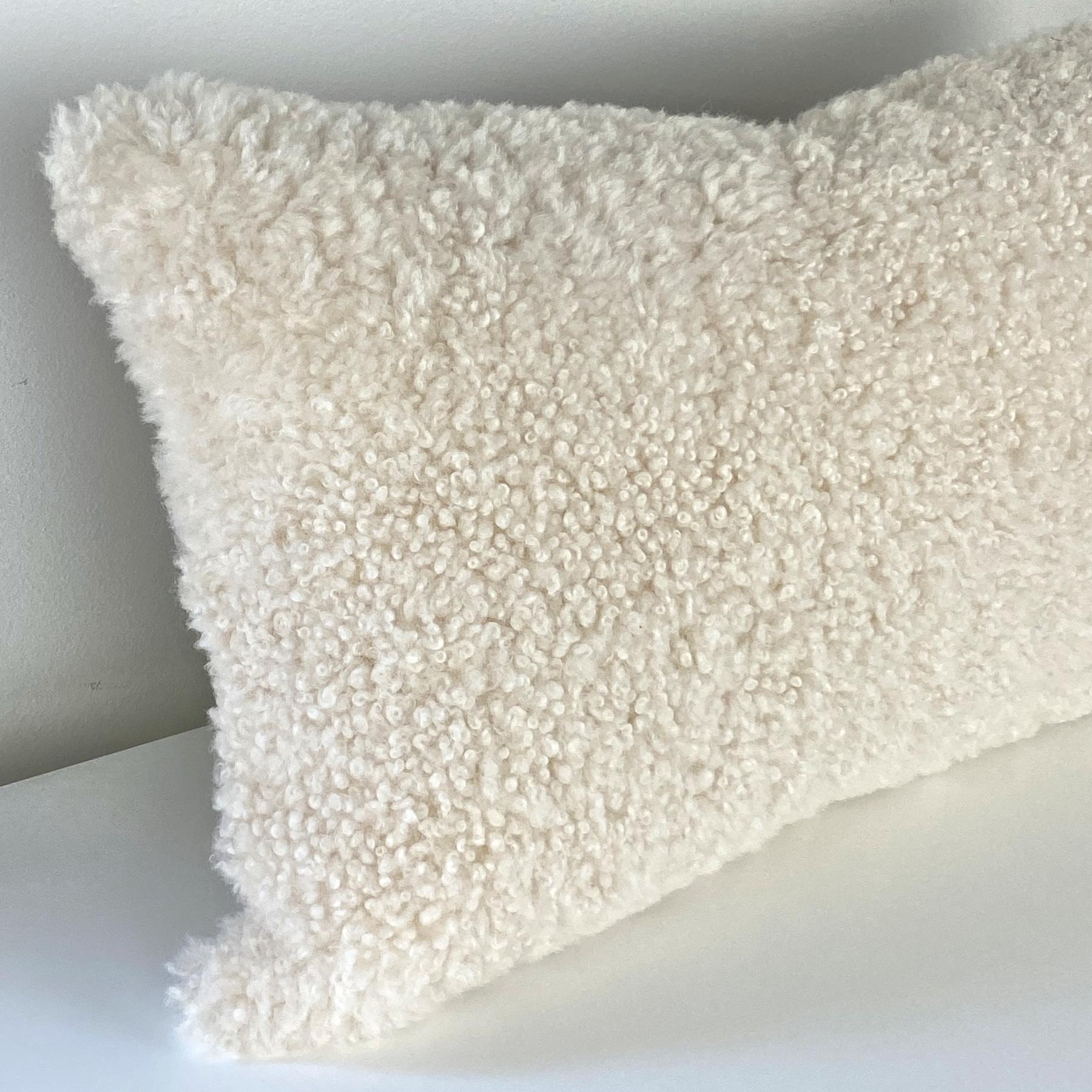 Add layers of 100% woolen textures to a decor with this captivating Australian shearling sheepskin pillow. The short curly wool pile translates stylish design, comfort and expresses natural signature living.
Limited edition piece exclusive only to
