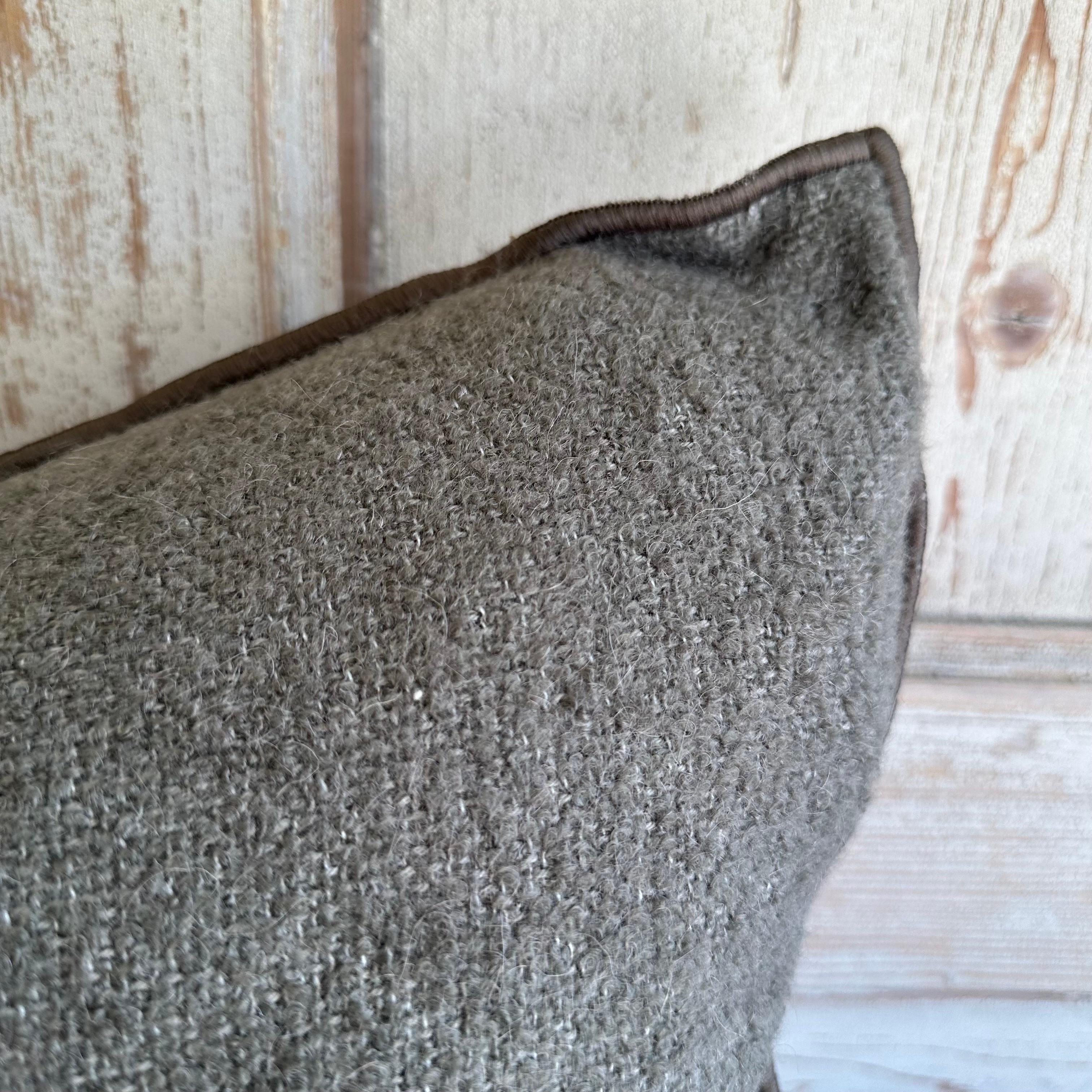 Bouclette French wool accent pillow
Custom wool blend accent pillow with down insert 
Color: ecorce which is a dark elephant gray colored nubby boucle style pillow with a stitched edge, metal zipper closure. 
Size: 14” x 24”
Our pillows are