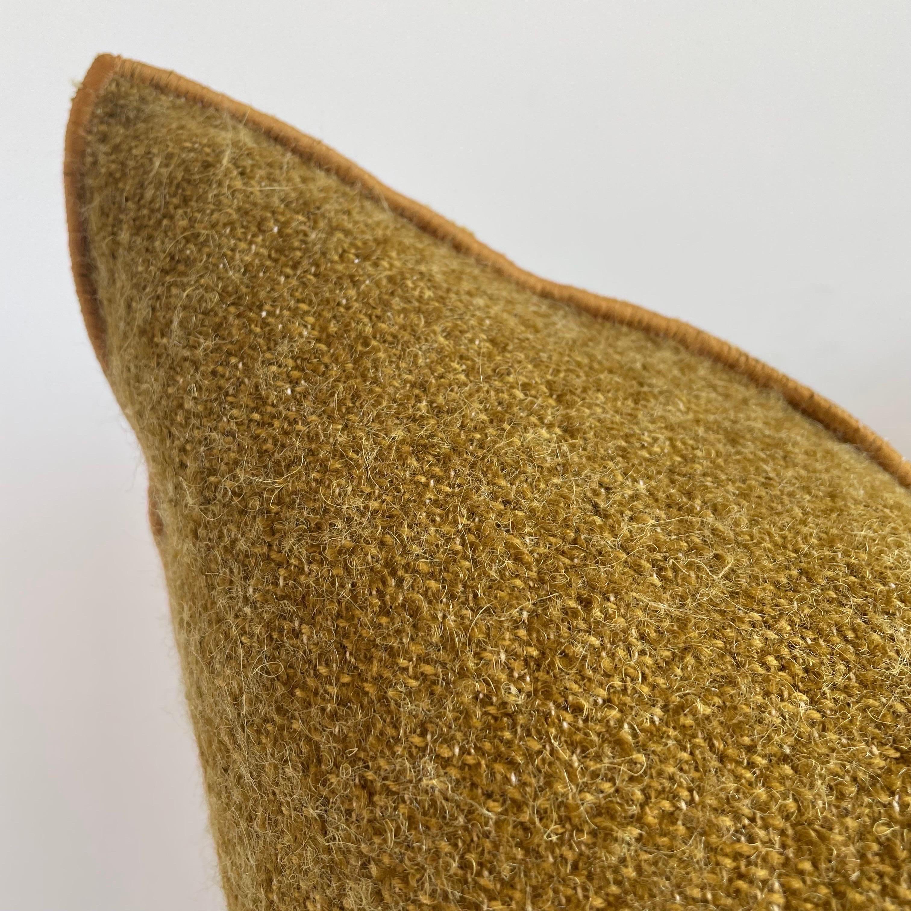 Custom wool blend accent pillow with down insert 
Color: Ocre 
A deep dijon, or similar to an aged brass, colored nubby boucle style pillow with a stitched edge, metal zipper closure. Our pillows are constructed with vintage one of a kind textiles