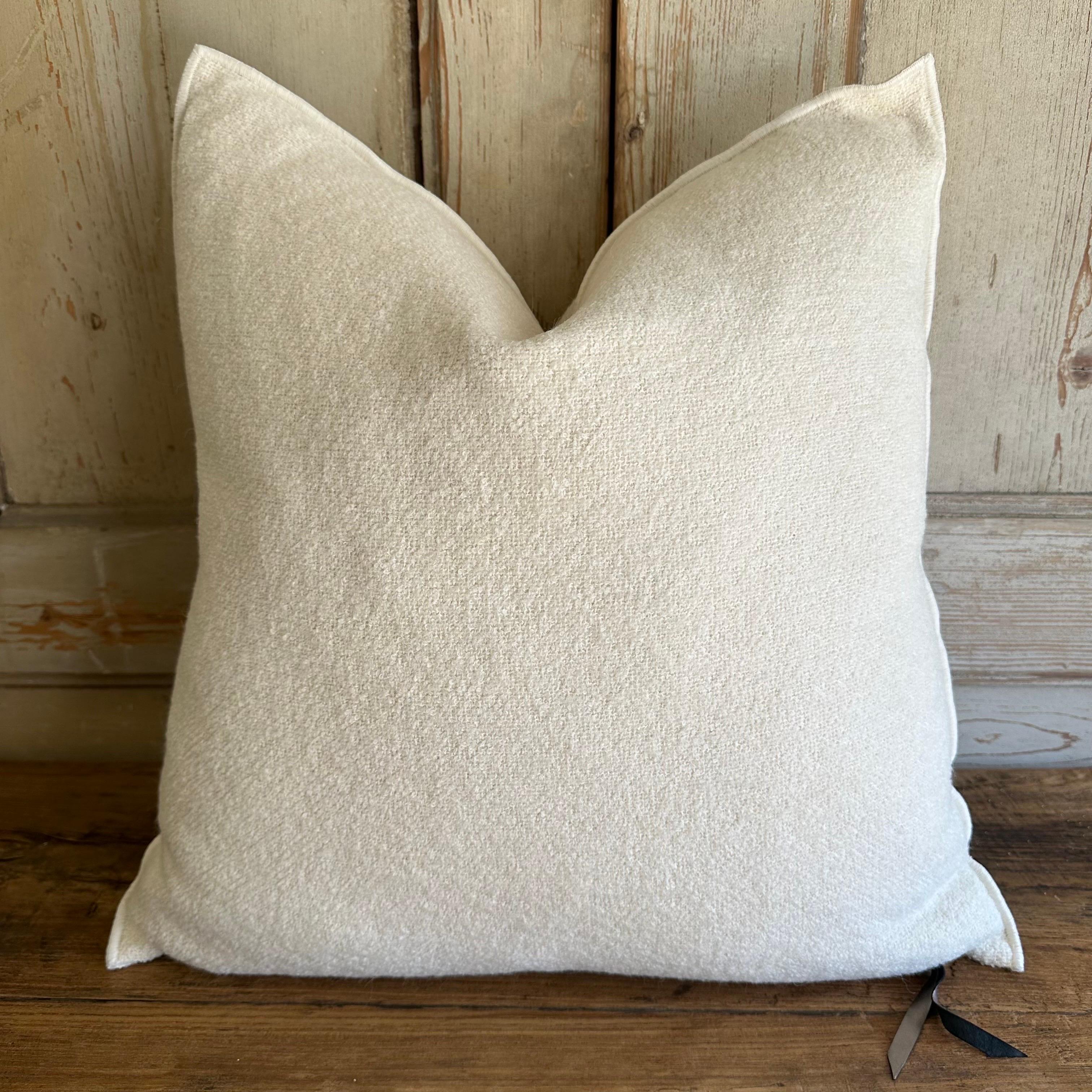 Bouclette French wool accent pillow.
Custom wool blend accent pillow with down insert 
Color: blanc, an off white colored nubby boucle style pillow with a stitched edge, metal zipper closure.
Size: 22” x 22”
Our pillows are constructed with