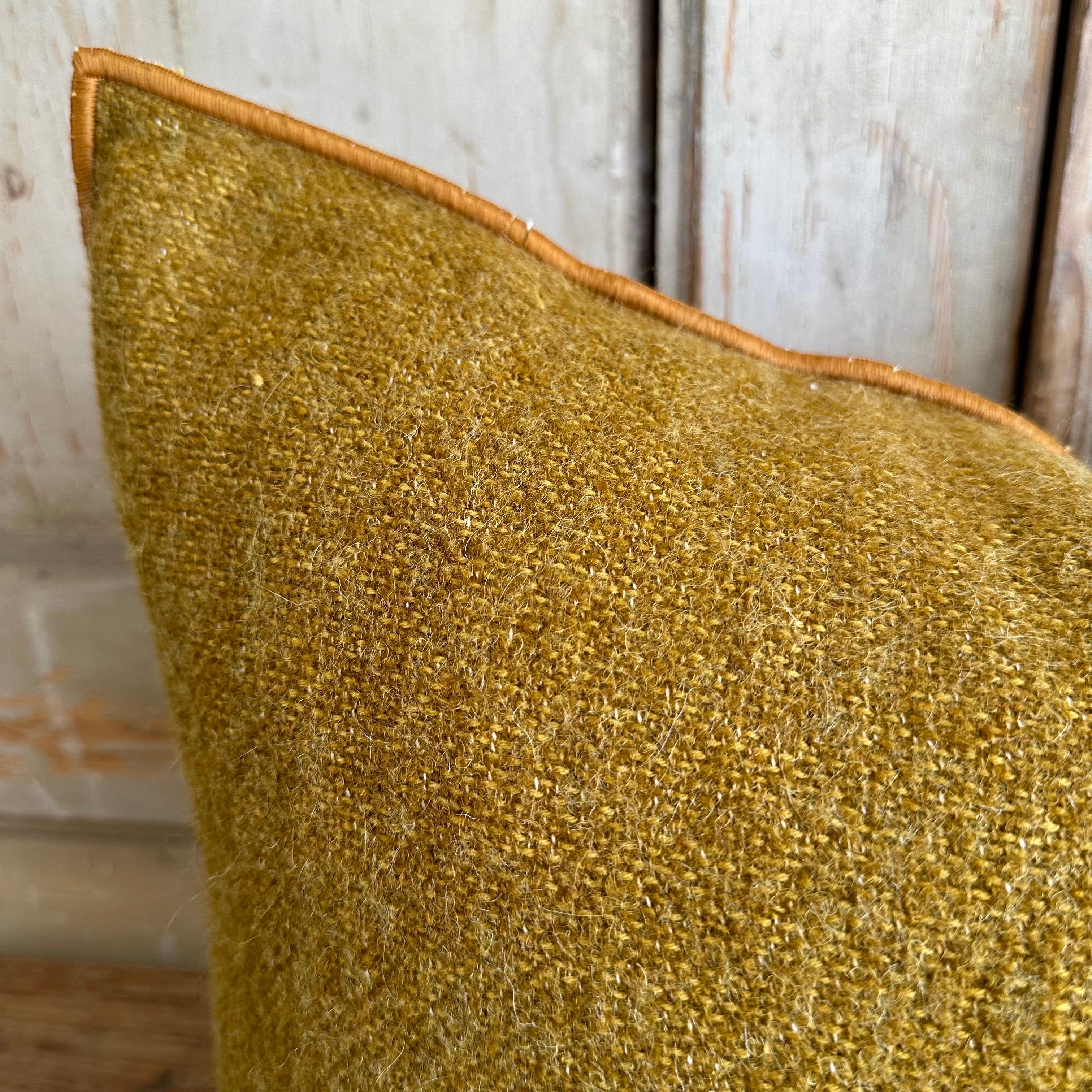 Custom wool blend accent pillow with down insert. 
Color: Ocre ; a mustard with warm brown tone colored nubby boucle style pillow with a stitched edge, metal zipper closure. 
Size: 14”x23”.
Our pillows are constructed with vintage one of a kind