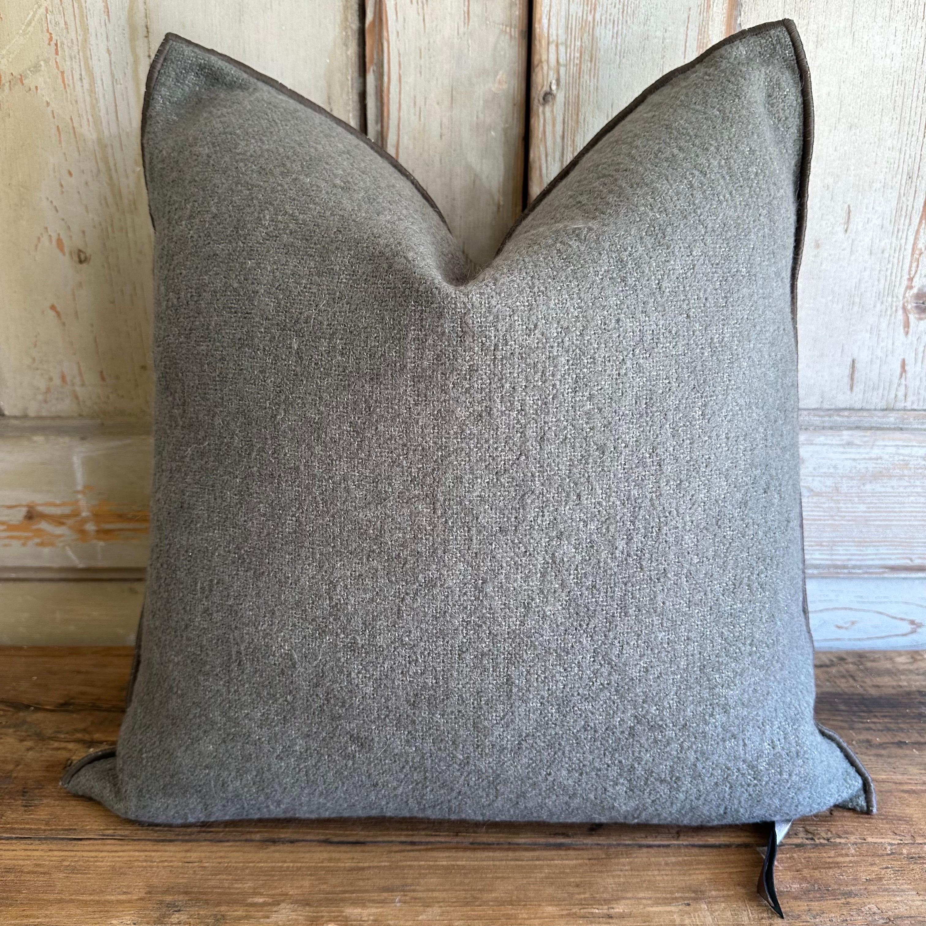 Custom wool blend accent pillow with down insert.
Color: ecorce which is a dark elephant gray colored nubby boucle style pillow with a stitched edge, metal zipper closure. 
Size: 22” x 22”
Our pillows are constructed with vintage one of a kind