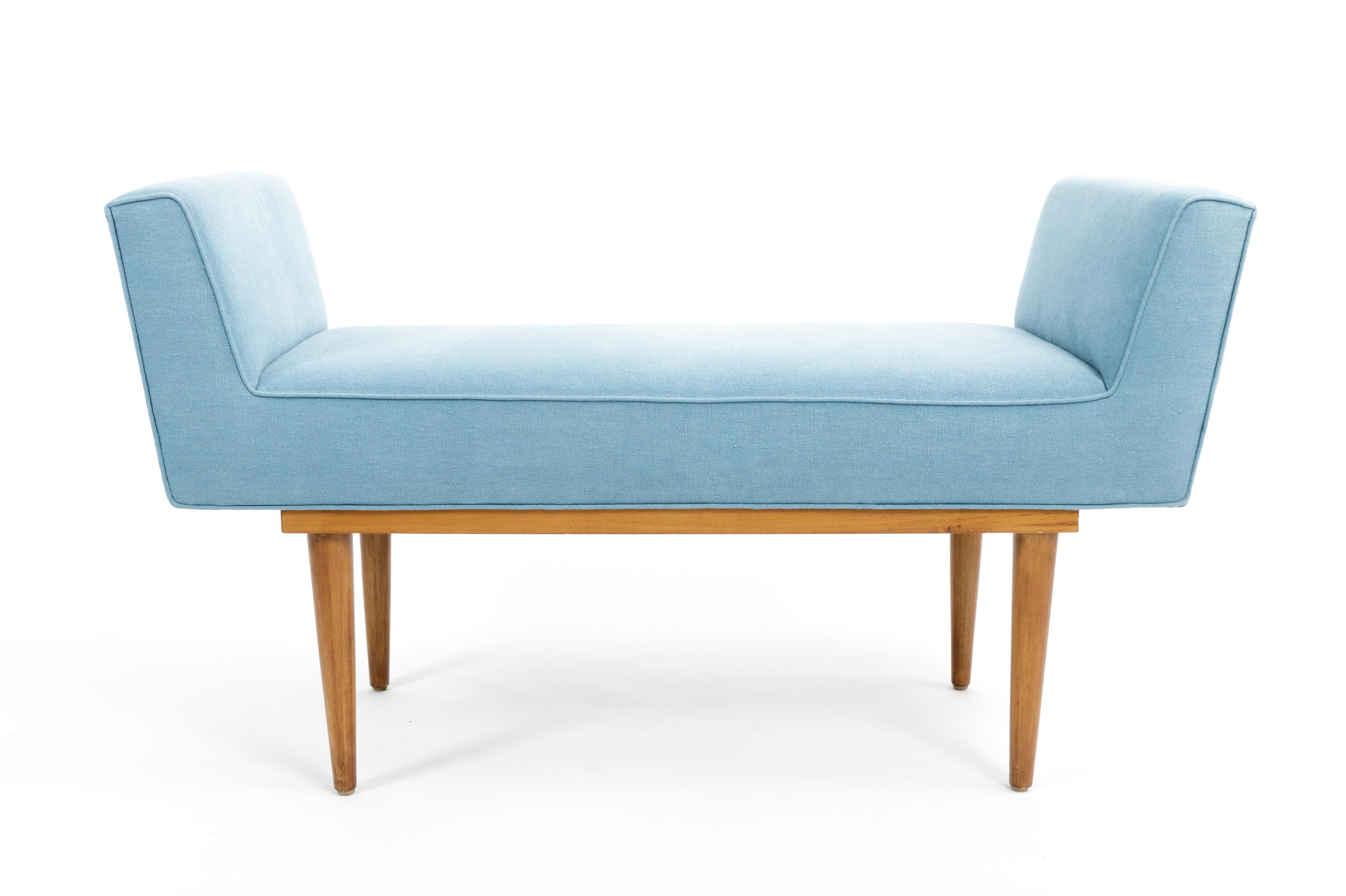 Elegant mid-century boudoir bench, c. 20th century. 

Simple yet sophisticated design consists of a handsome wood base and upholstered arms and seat. The bench in great vintage condition and has been newly recovered in a denim blue linen. 


