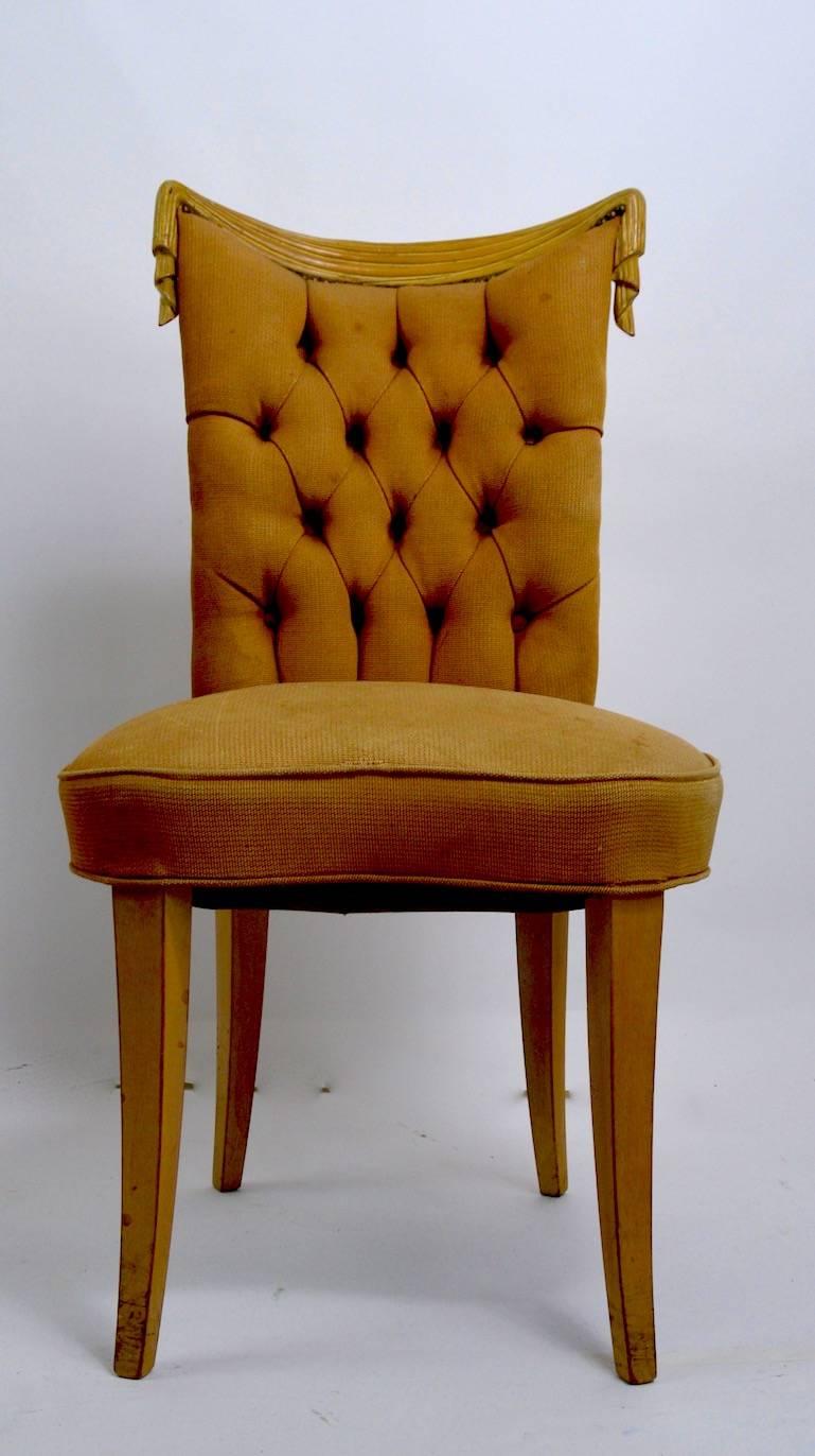 Glamorous, chic and stylish side, occasional, boudoir chair by Grosfeld House. Carved wood drape back, tufted backrest, upholstered pad seat. This example will need to be restored as the upholstery is worn, and the chair is a bit wiggly. Plenty of