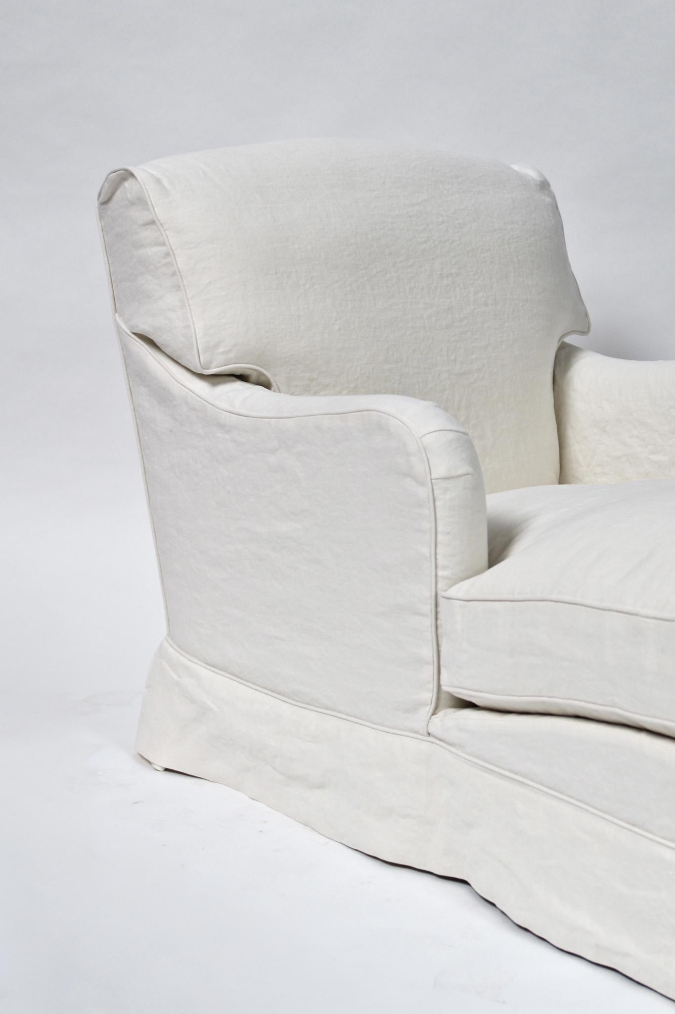 Le lit de jour Boulbon de am designs est une version audacieuse et allongée du fauteuil club classique. Fabriqué à la main en Belgique avec un cadre en bois massif, il présente de larges accoudoirs, une assise profonde et des lignes fortes et