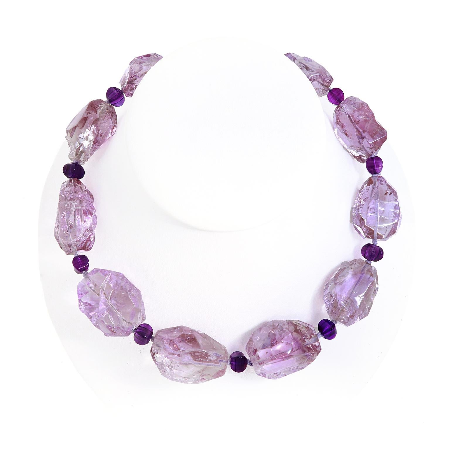The beauty of amethyst revolves in this necklace. A crystalline display of lilac and violet sparkles in boulder shapes of the gem as the focus. In between each boulder is an accent of a single roundel of the gem in a deeper hue. The collective
