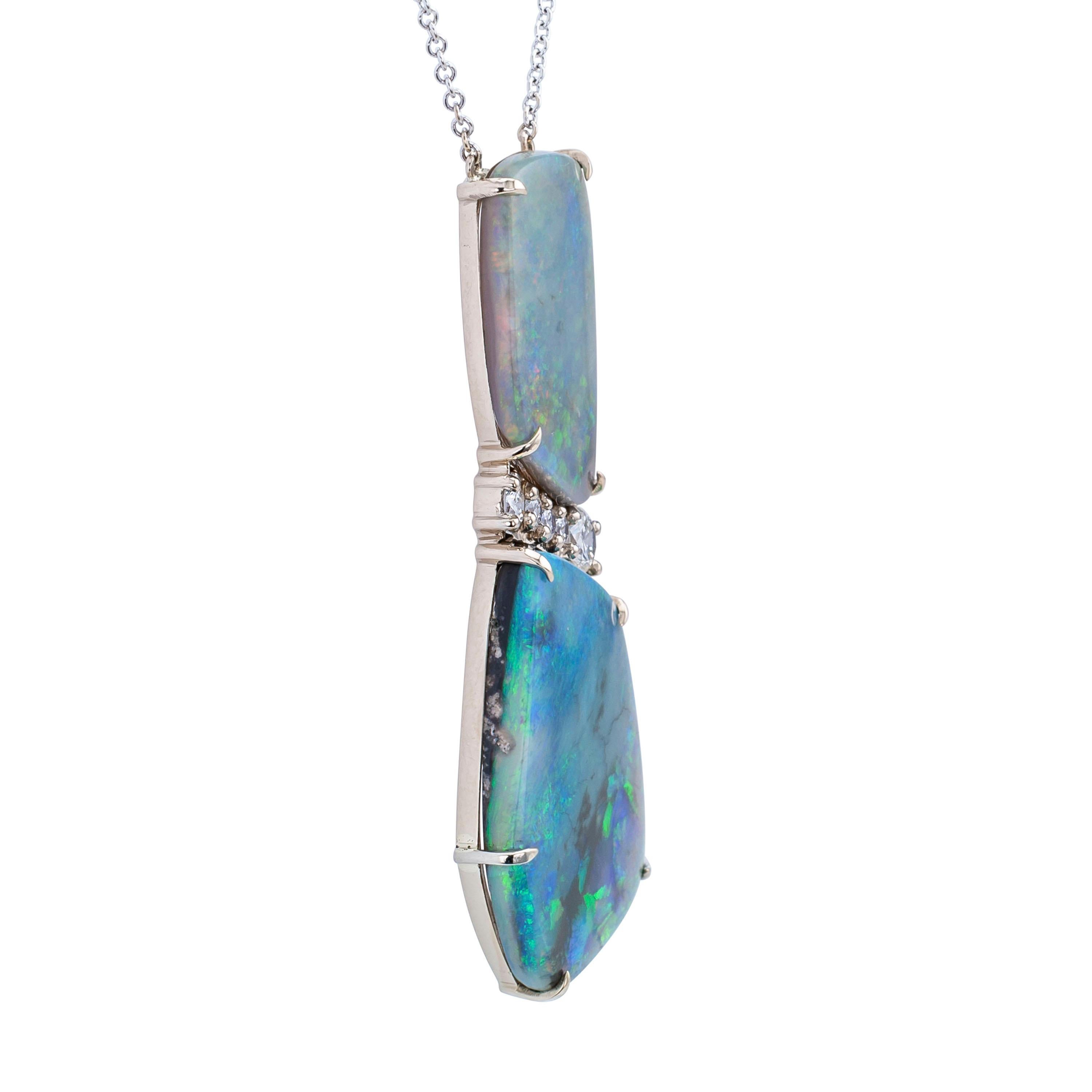 Free form boulder black opal diamond and white gold necklace.

DETAILS:
Boulder black opal diamond and white gold necklace.
GEMSTONES: two free form boulder black opals together weighing approximately 19.95 carats.
DIAMONDS: five round brilliant-cut