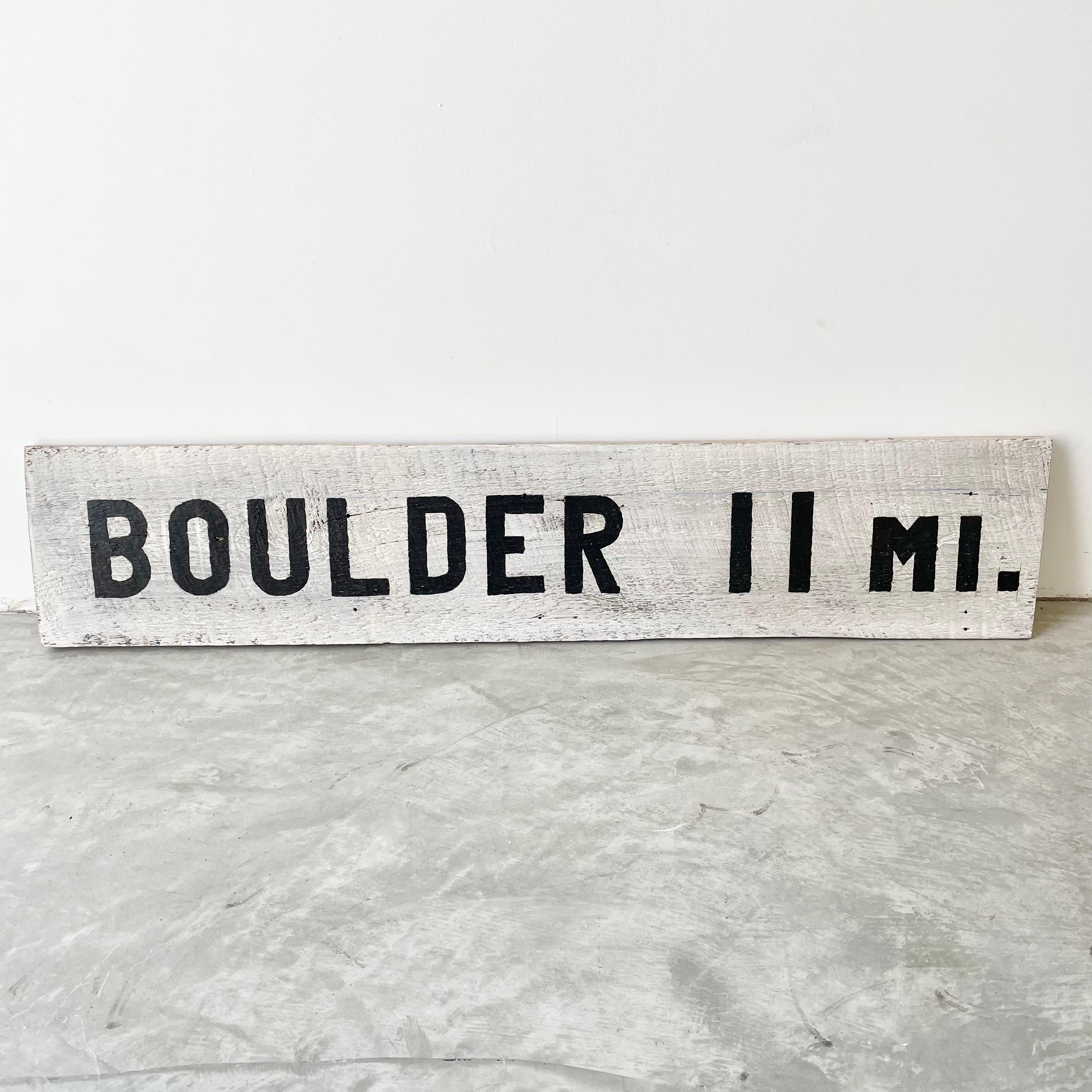 Rustic hand painted Boulder road sign in black and white. Painted on a 3/4
