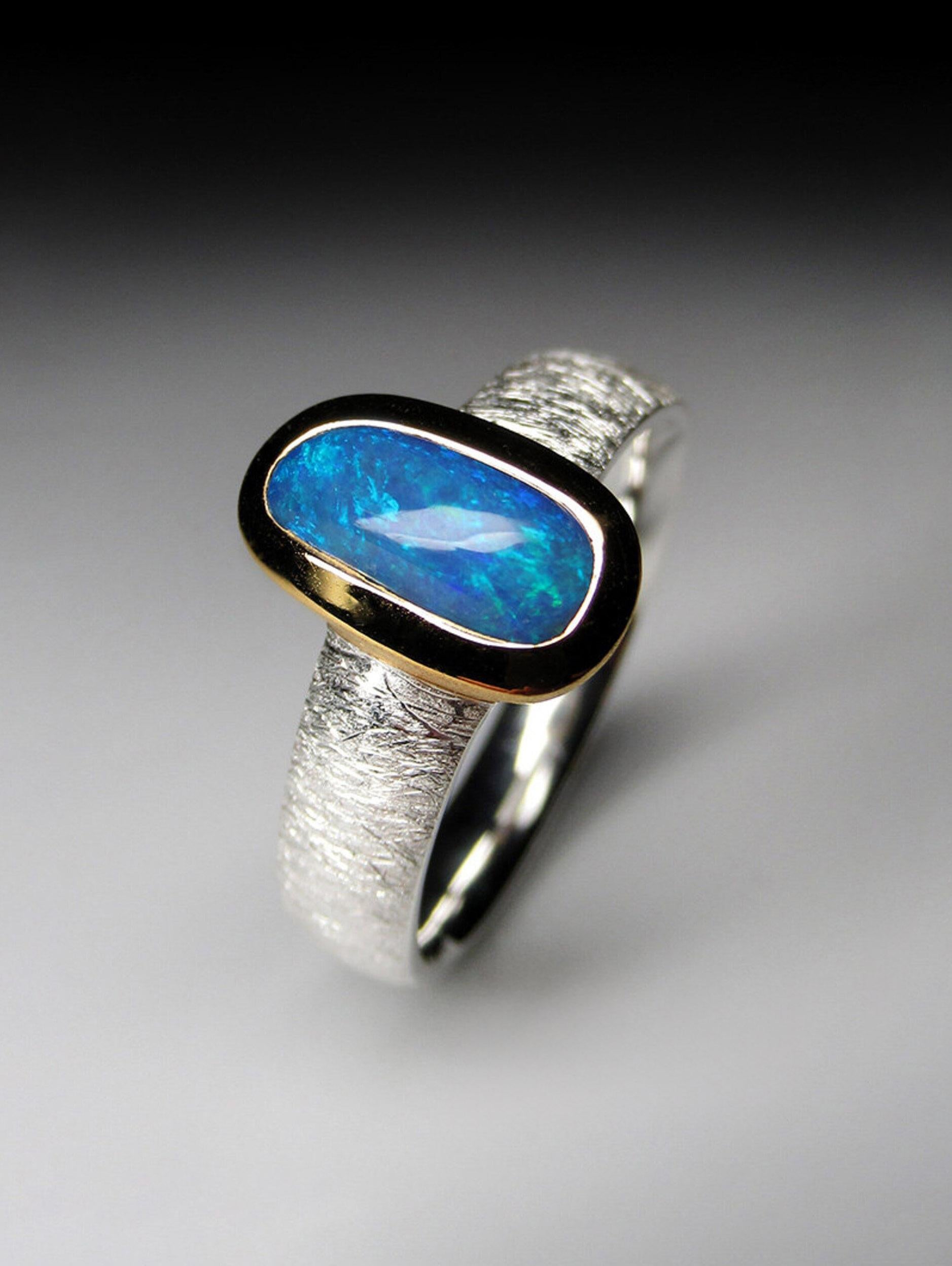 Matte finish silver 18K gold plated ring with fine quality blue Boulder Opal
gemstone origin - Australia
ring weight - 4.61 grams
ring size - 8 1/2 US 
gemstone size - 0.12 х 0.16 x 0.39 in /  3 х 4 х 10 mm