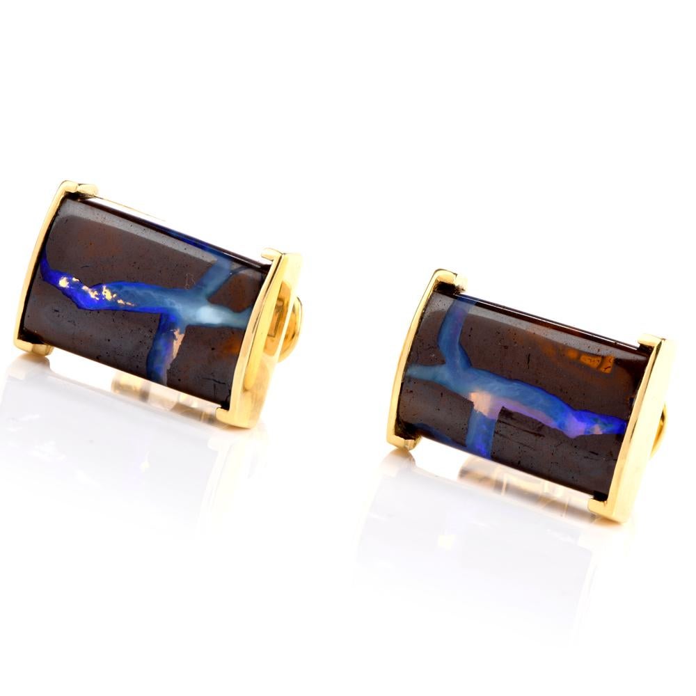 These cosmic boulder opal cufflinks are crafted in 18-karat yellow gold, weighing 26.4 grams and measuring 22mm x 15mm. Showcasing a pair of rectangle prong-set boulder opals, weighing approximately, 21.70 carats. In excellent condition.

 This