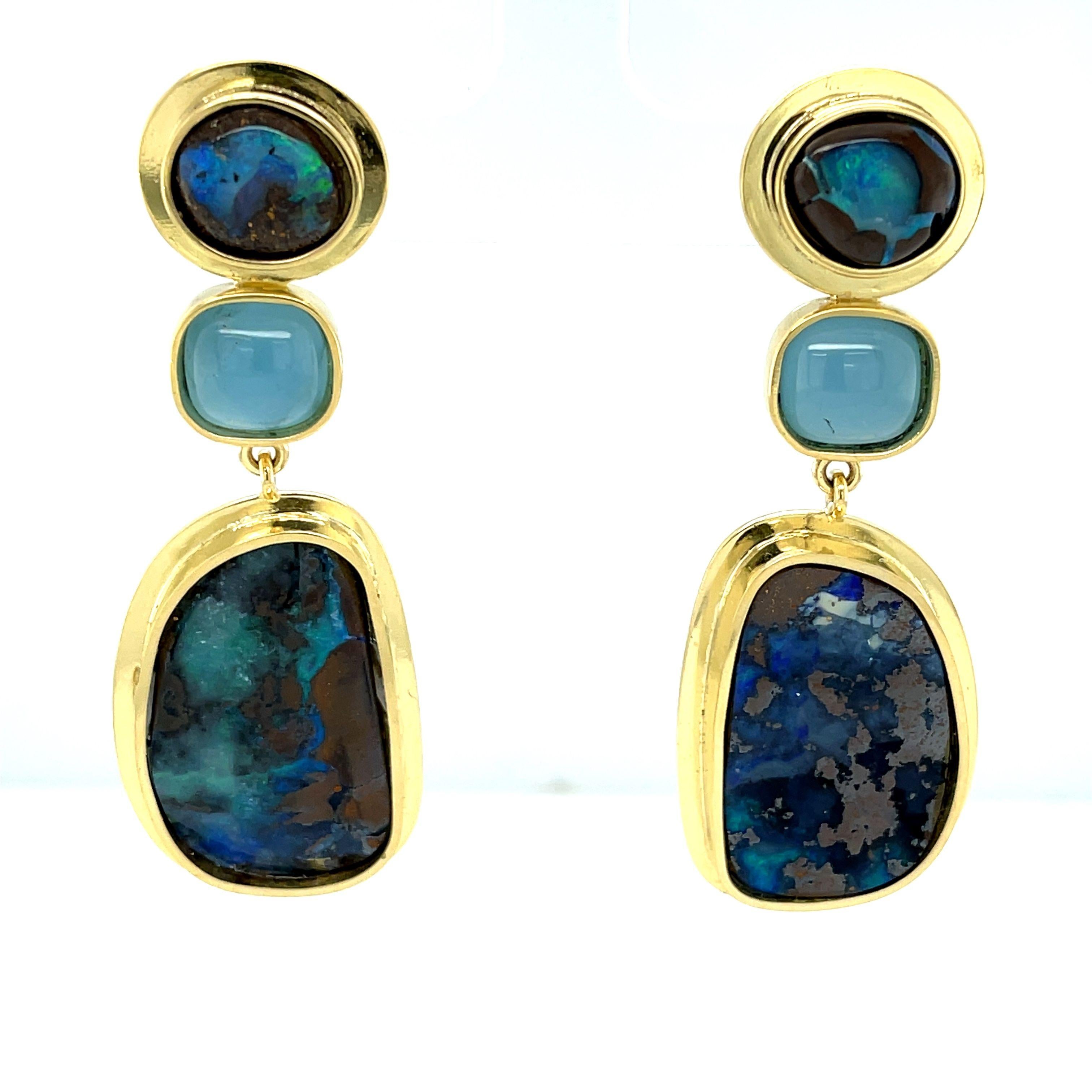 These one-of-a-kind boulder opal earrings have a truly organic feel and an air of worldly sophistication! A pair of large, freeform boulder opals show off a gorgeous array of turquoise, indigo and tahitian blues against dramatic dark brown matrix.