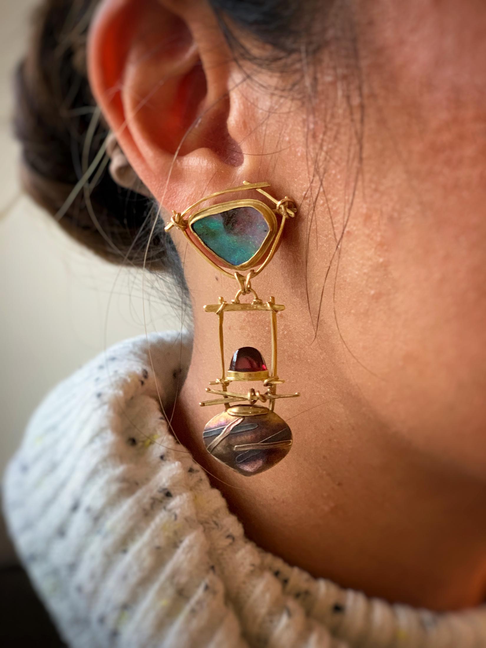Original, hand made earrings by Designer Carolyn Morris Bach.  Beautiful Freeform Boulder Opals approx 11mm x 11mm are bezel set in Carolyn's trademark gold work.  Polished Half Moon Garnets are bezel set in the drop part of the earrings.  Post