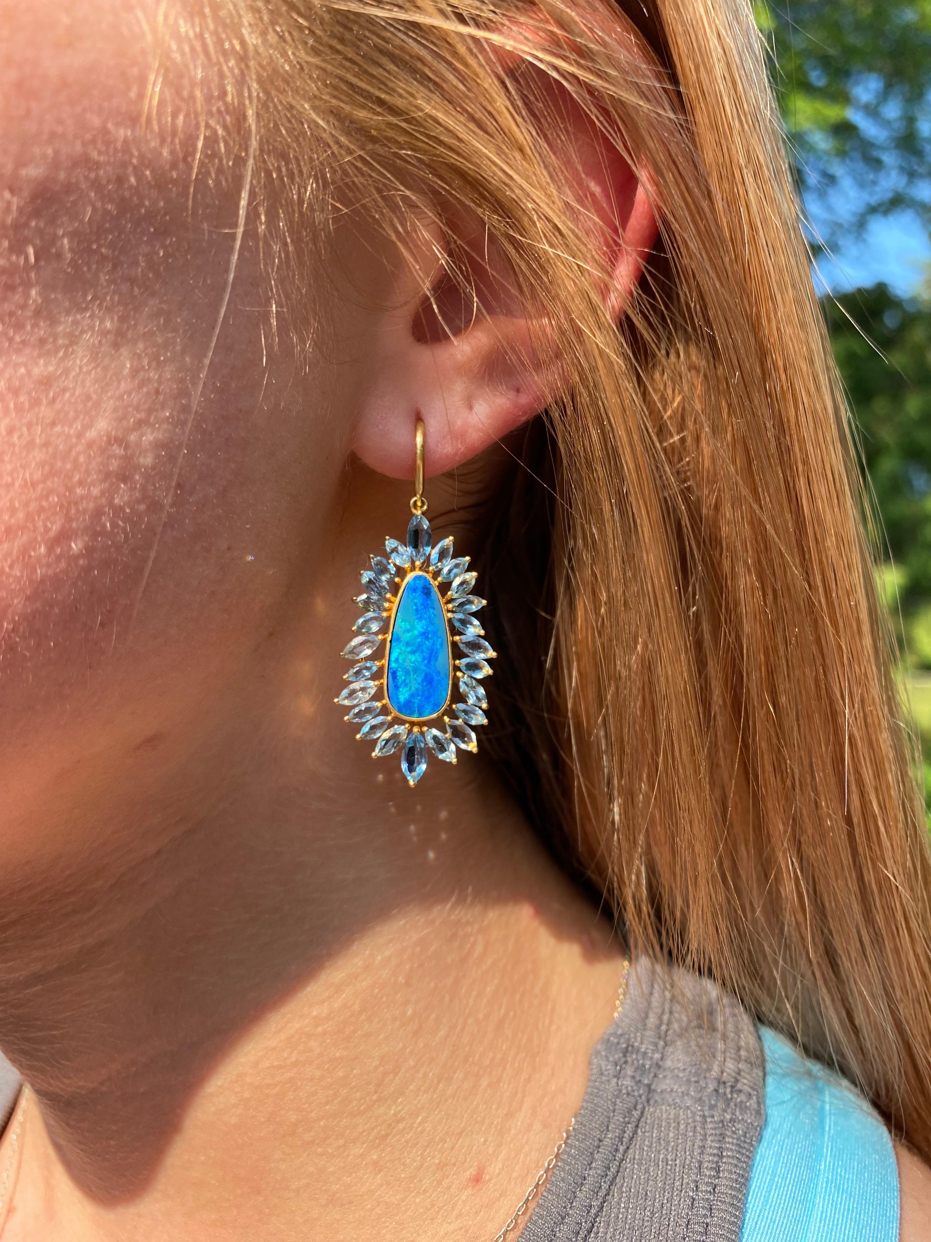 These stunning blue Boulder Opal center stones have such depth of color they catch the eye from across a room!  They capture all of the deep and bright colors of the Caribbean Ocean! Designed by award winning jewelry designer, Lauren Harper, the