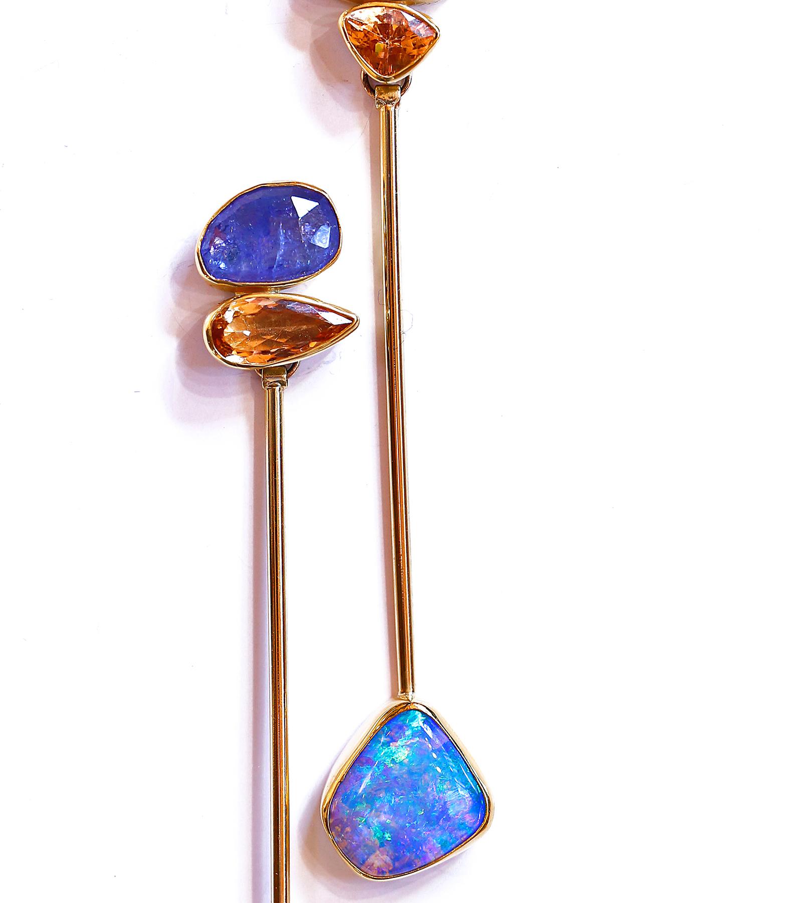A really great looking pendulum earring with opal in petrified wood, tanzanite and natural topaz.
Opal is found in many types of matrix's. These earrings are opal in petrified wood! Amazing really. The color and depth of the opal is lovely, framed