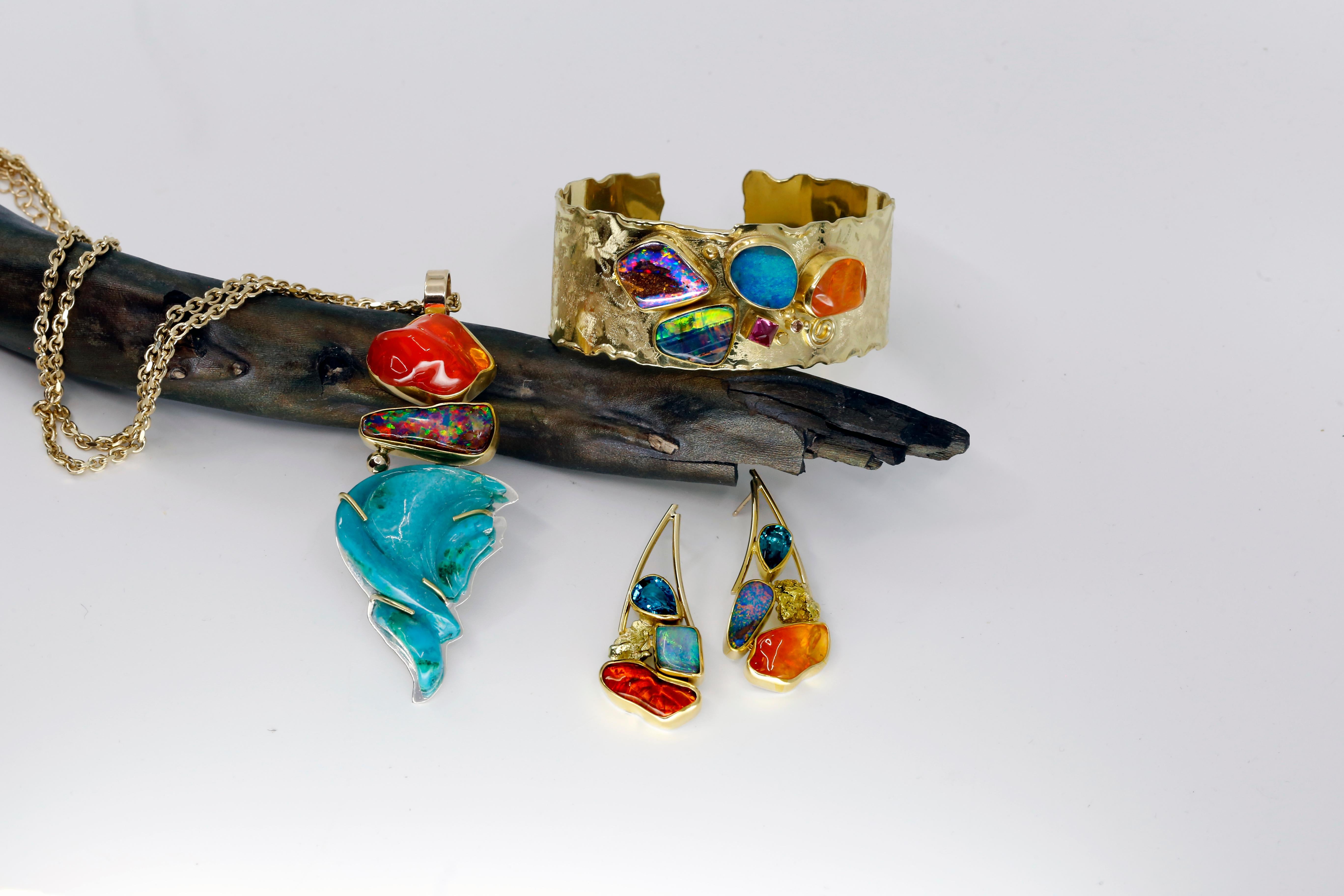 These boulder opal and Mexican opal earrings with Alaskan gold nuggets and apatite are alive with color and fire. The earrings have the colors of sunsets and sunrises. The high carat gold of 22k and 18k holds  the color perfectly. The earring is