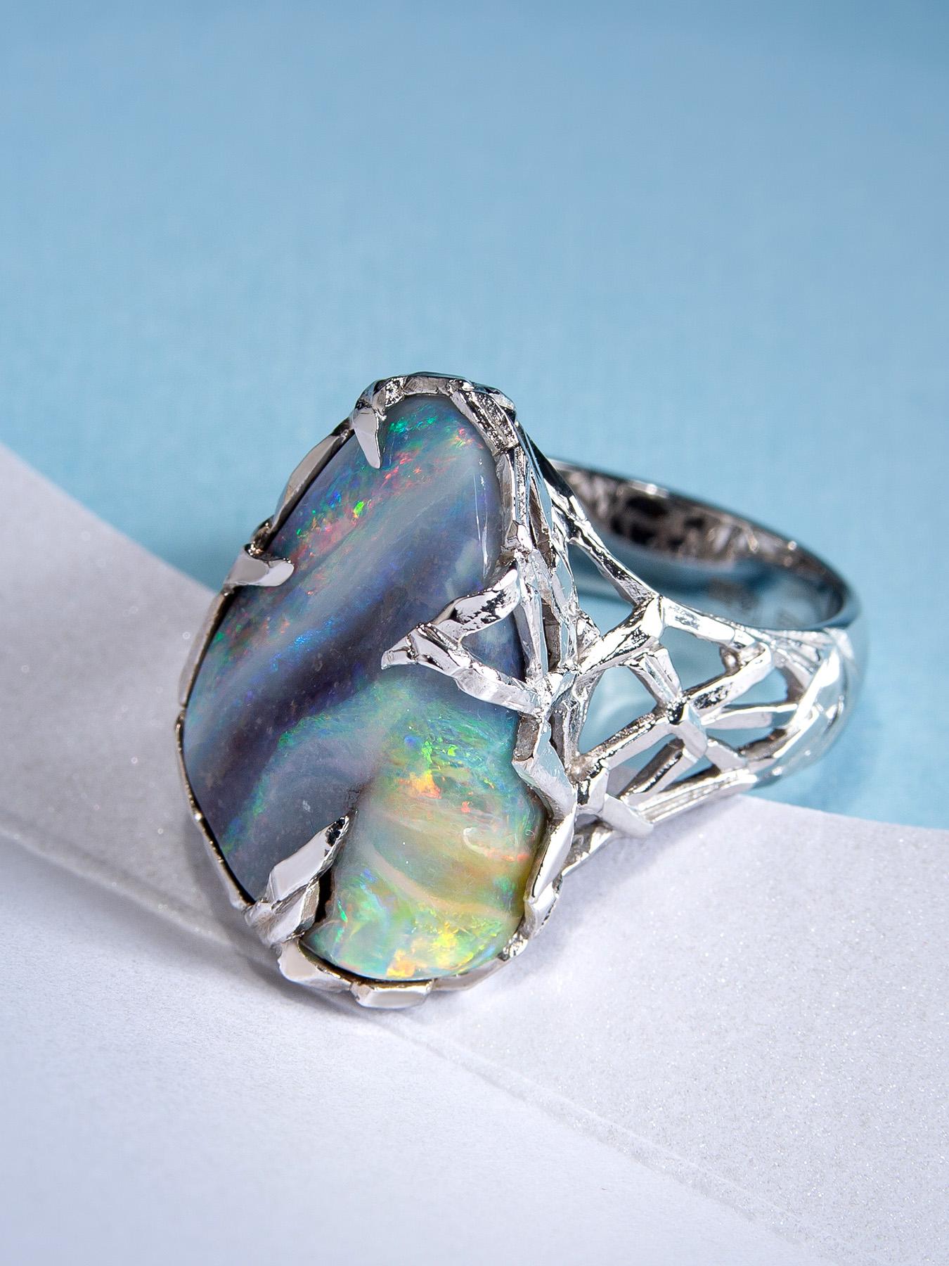 This ring has a majestic Boulder Opal in a sublime White Gold body that has a medieval structured design. Crafted with utmost precision, the Boulder Opal has a brilliantly polished surface along with its gorgeous play of color, lofty color bar, and