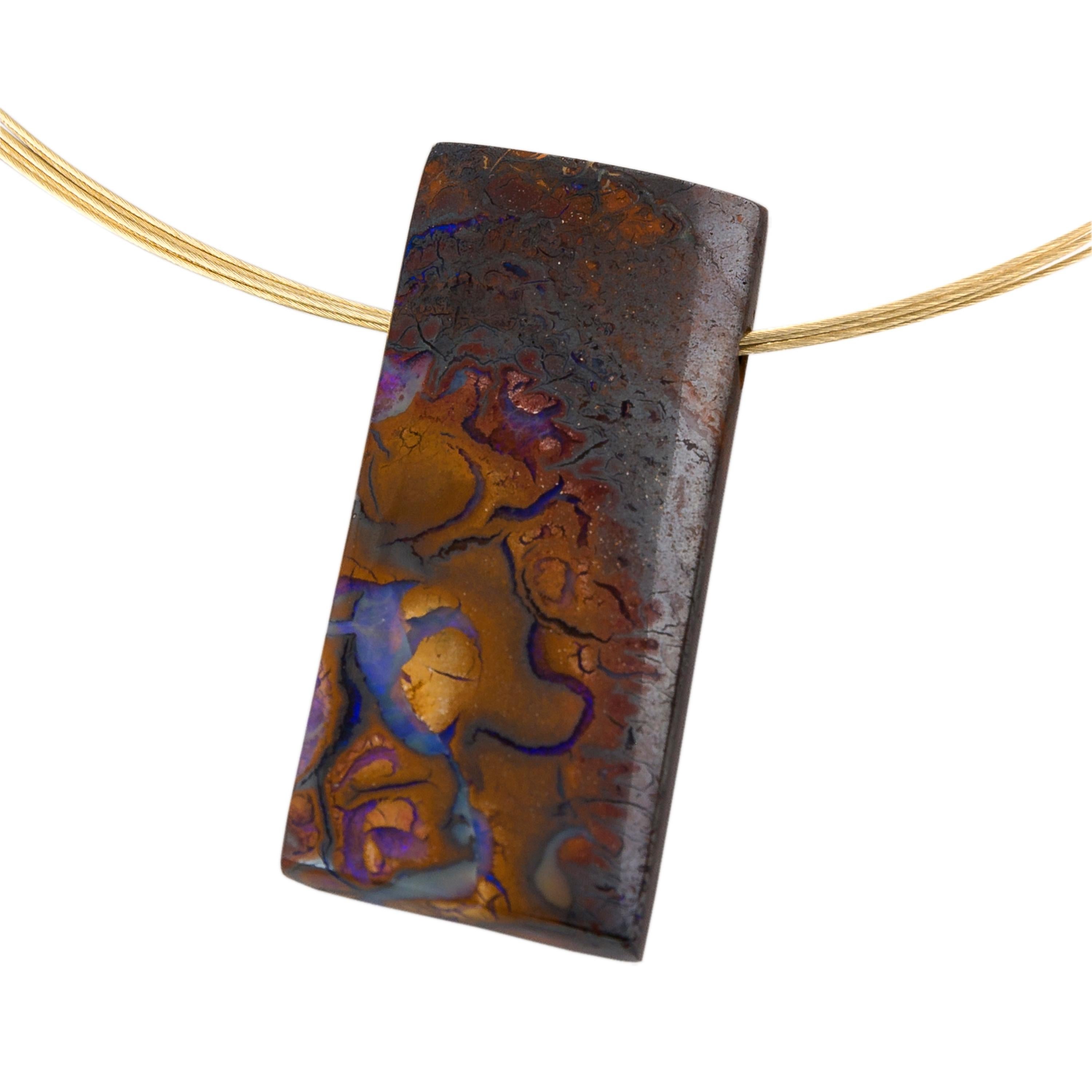 A stunning Australian Boulder Opal pendant on a 14 Karat gold multi strand collar necklace.
Boulder Opal is a unique and beautiful type of Opal found only in Queensland, Australia. It is characterised by the marbled effects of blues, purples and