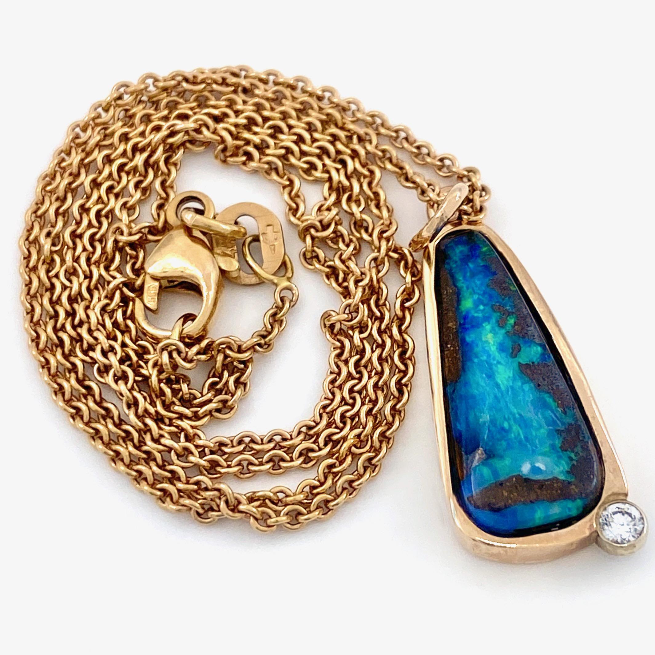 Eytan Brandes made this 14 karat rose gold pendant to show off a great little boulder opal he bought from an Australian dealer several years ago.  

With a great range of colors, all in the blue-green spectrum, the opal shows fire from the right,
