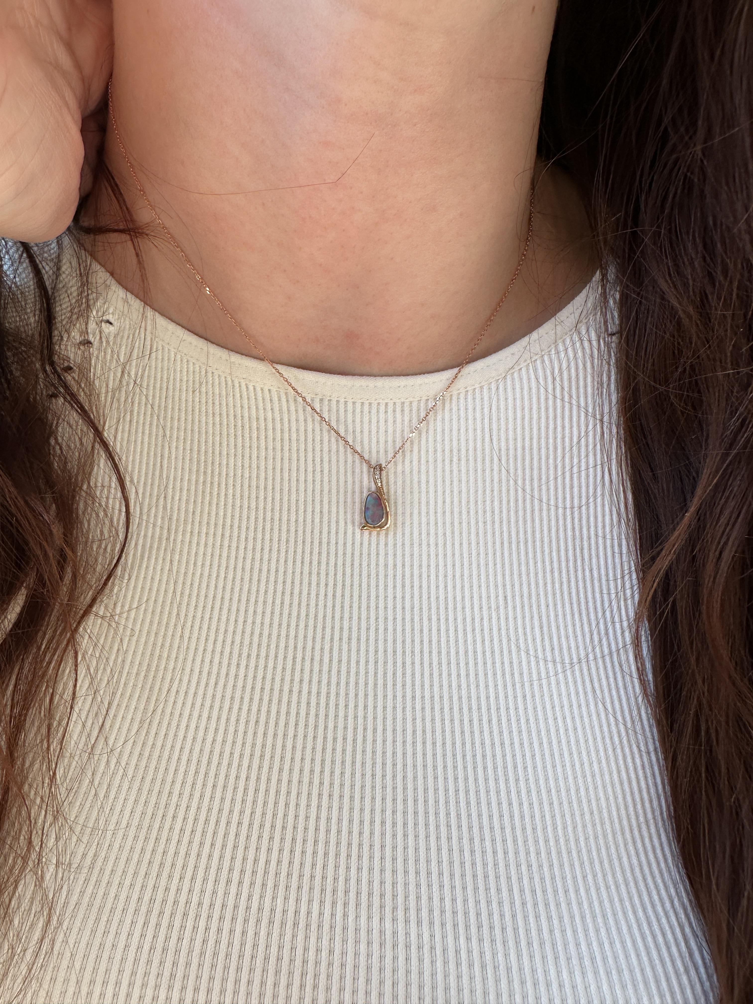 This exquisite unique pendant features a 0.71 carat boulder opal gemstone with natural earth mined diamonds set in solid 14K gold. This opal pendant makes a lovely October birthstone gift for your loved ones! **Chain Sold Separately**

**We offer