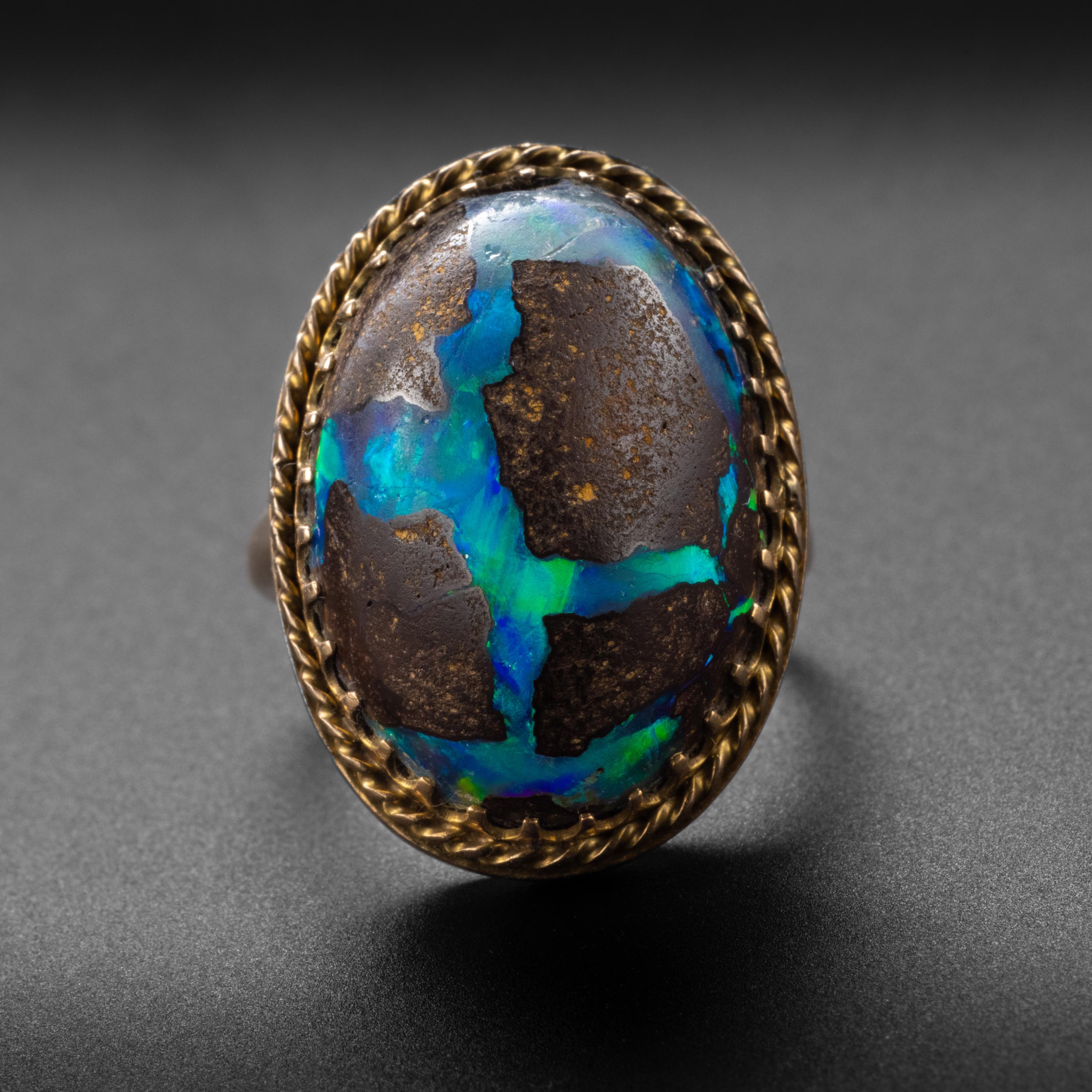 This boulder opal is a cabochon of dark brown ironstone struck by lighting bolts of brilliant blue and green. Boulder opals from Australia -like the one you see in this ring from the 1940s- are the most highly prized.

What I love about this boulder