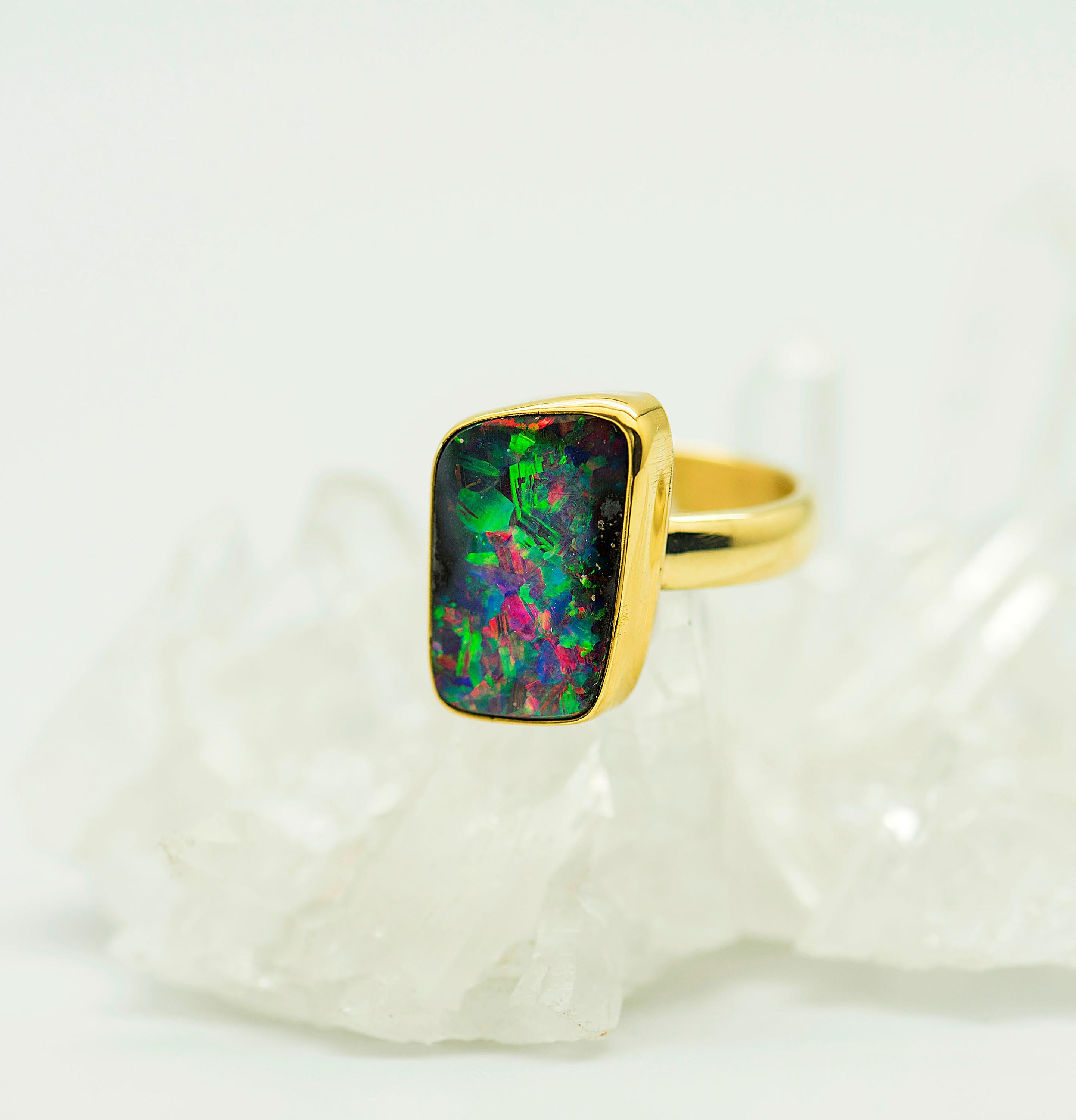 The beauty of boulder opal is not only seen in its color, but also the variety of the type of pattern the opal has.   This boulder opal ring has every color of the rainbow, including red, which is the most rare  color.  It's pattern is Criss-Cross,