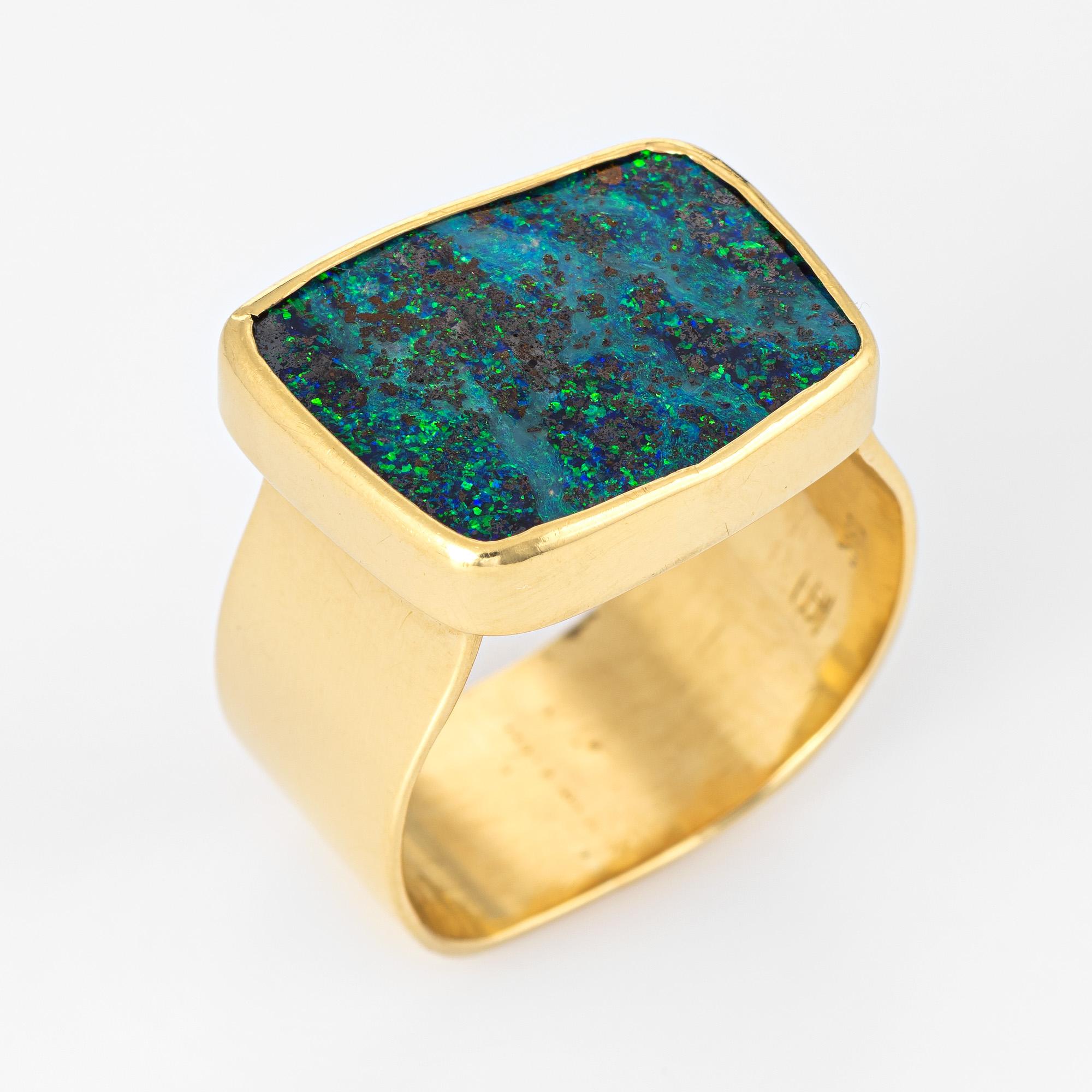 Stylish vintage boulder opal cocktail ring (circa 1980s to 1990s) crafted in 18 karat yellow gold. 

Boulder opal is inlaid flush into the mount measuring 17mm x 12.5mm. The opal is in excellent condition and free of cracks or chips. 

The opal